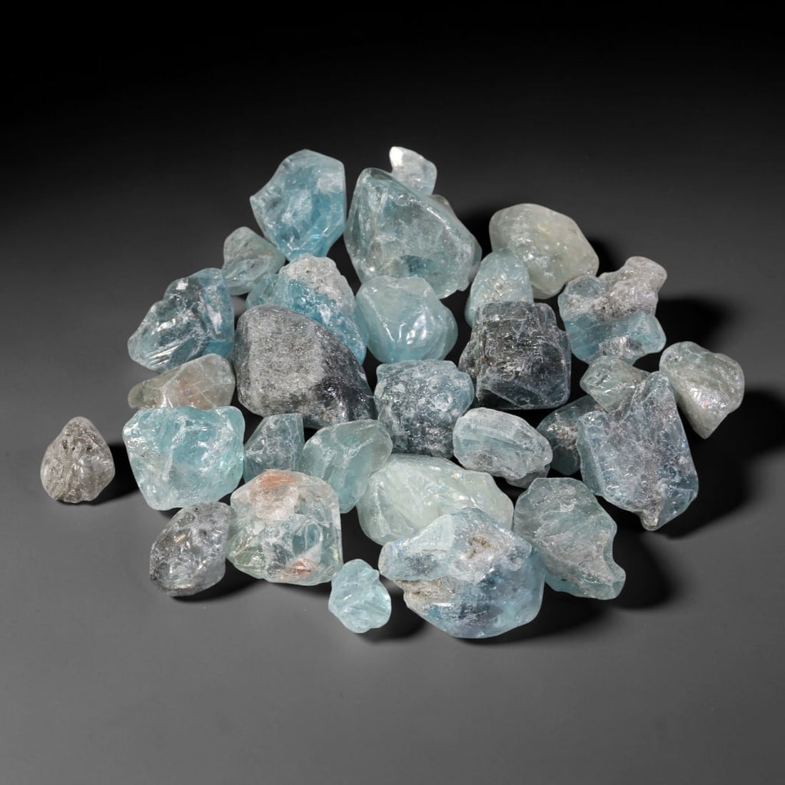 234.19ct Natural Cambodian Blue Zircon Rough Parcel Loose Gemstone, 76YT: This parcel consists of natural unpolished blue zircon rough crystals with translucent sky-blue to teal hues, featuring natural crystalline textures and facets. Minor matrix and inclusions are visible
