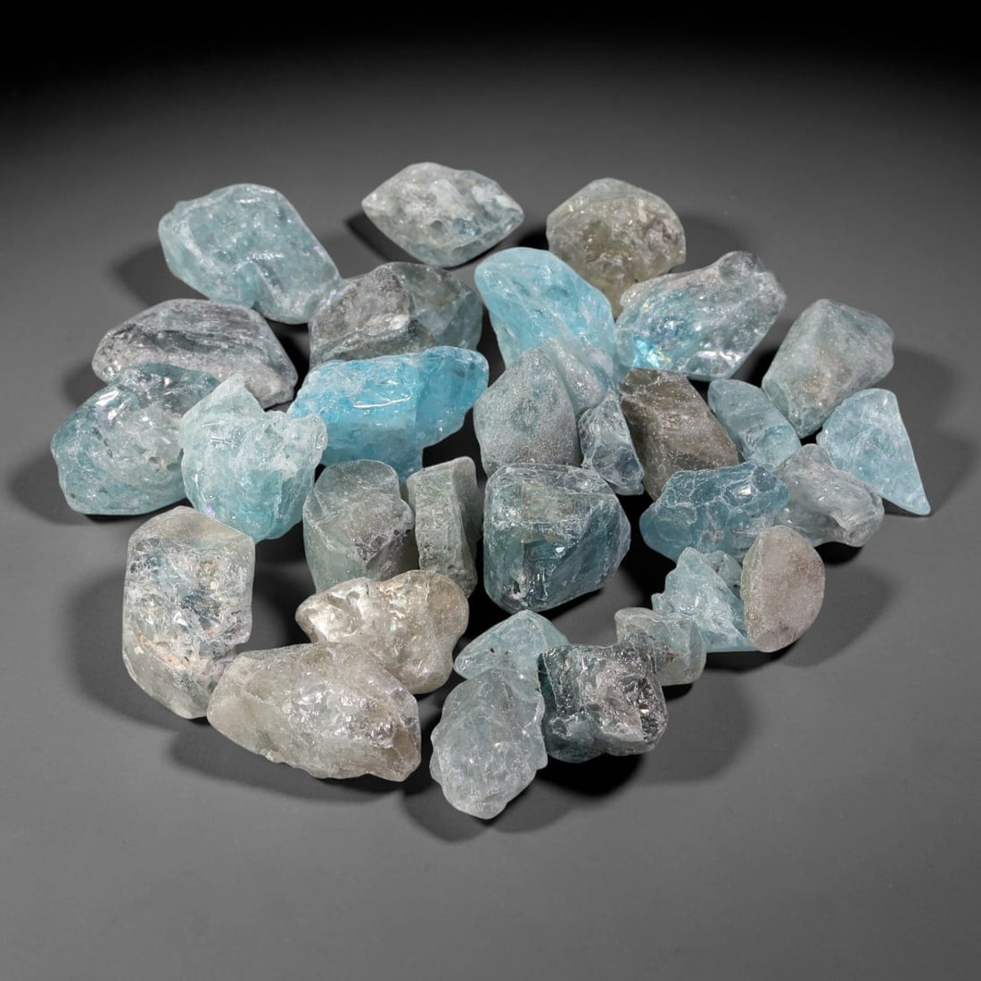 227.27ct Natural Cambodian Blue Zircon Rough Parcel Loose Gemstone, 82YT: This parcel consists of natural unpolished blue zircon rough crystals with translucent sky-blue to teal hues, featuring natural crystalline textures and facets. Minor matrix and inclusions are visible