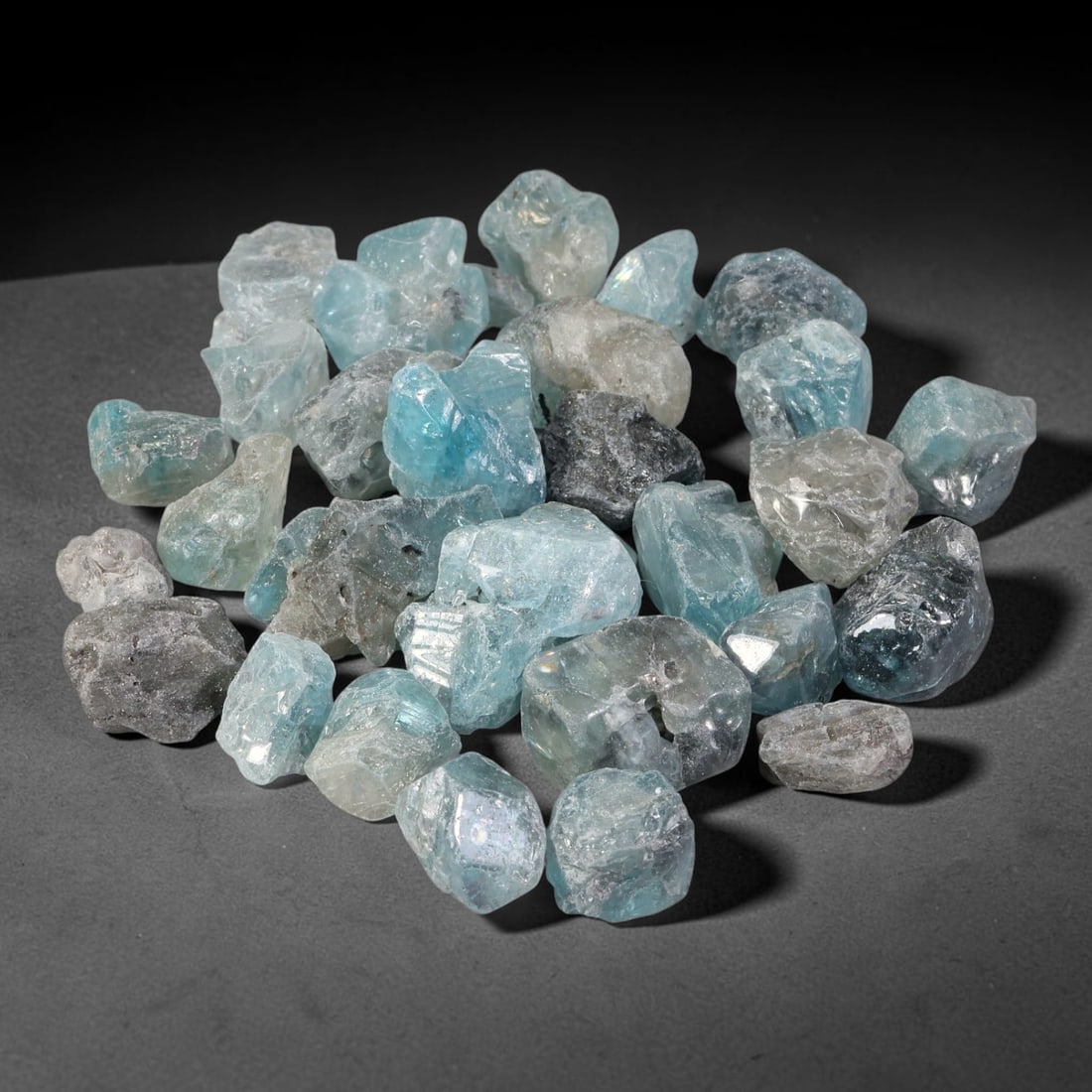 242.32ct Natural Cambodian Blue Zircon Rough Parcel Loose Gemstone, 70YT: This parcel consists of natural unpolished blue zircon rough crystals with translucent sky-blue to teal hues, featuring natural crystalline textures and facets. Minor matrix and inclusions are visible