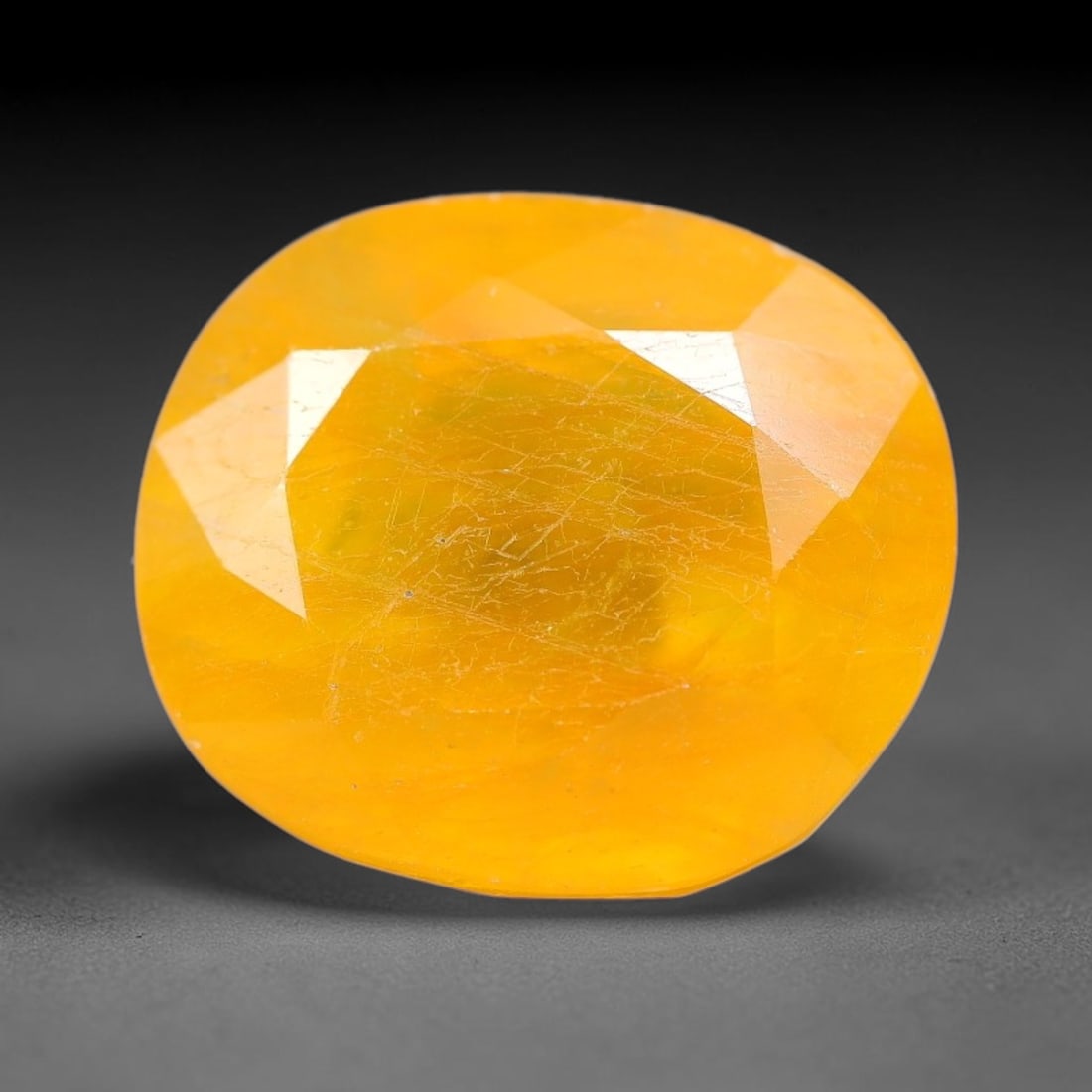 14.85 Carats Yellow Sapphire Oval Faceted Loose Gemstone, 89TM: This classic oval faceted sapphire displays rich saturated yelow color glowing through crisp polished multi-facet cuts, featuring natural fine internal fissures and tiny scattered mineral micro specks