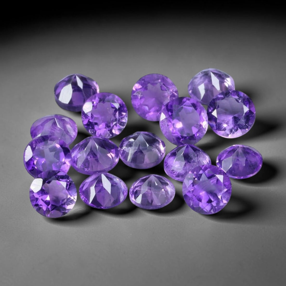 4.17ct Natural Purple Amethyst Round Cut Loose Gemstone Parcel, 23TZ: This parcel contains round faceted natural amethyst gemstones with aggregate total weight of 3.25 carats, each stone measuring 4.2x3.3mm. The gems display rich purple colouration with subtle natural i