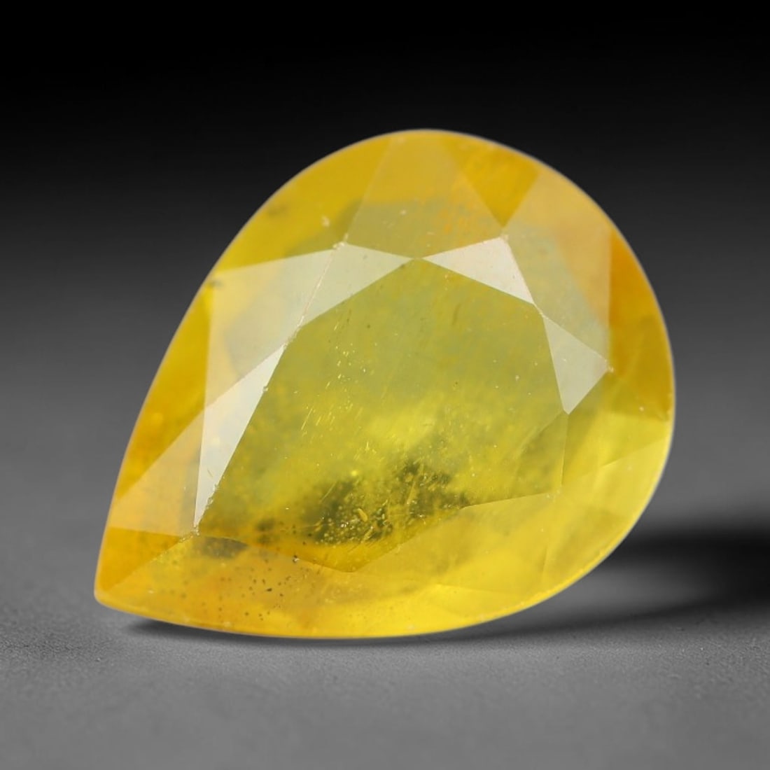 2.11 Carats Natural Yellow Sapphire Pear Faceted Loose Gemstone, 46YW: This natural yellow sapphire features a classic Pear brilliant faceted cut, holding consistent warm golden-yellow color throughout the corundum crystal. Fine microscopic mineral specks and faint natur