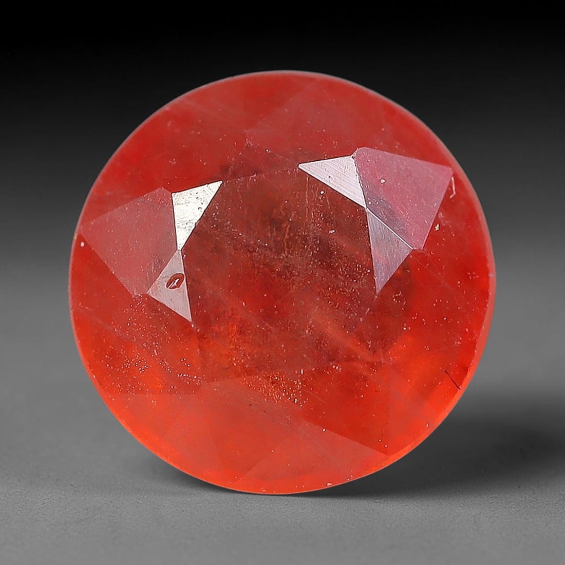 1.11 Carats Natural Orange Sapphire Round Faceted Loose Gemstone, 80YW: This natural orange sapphire is fashioned in a classic round brilliant faceted cut, presenting soft warm orange hues consistent with natural corundum specimens. Fine scattered mineral specks and faint