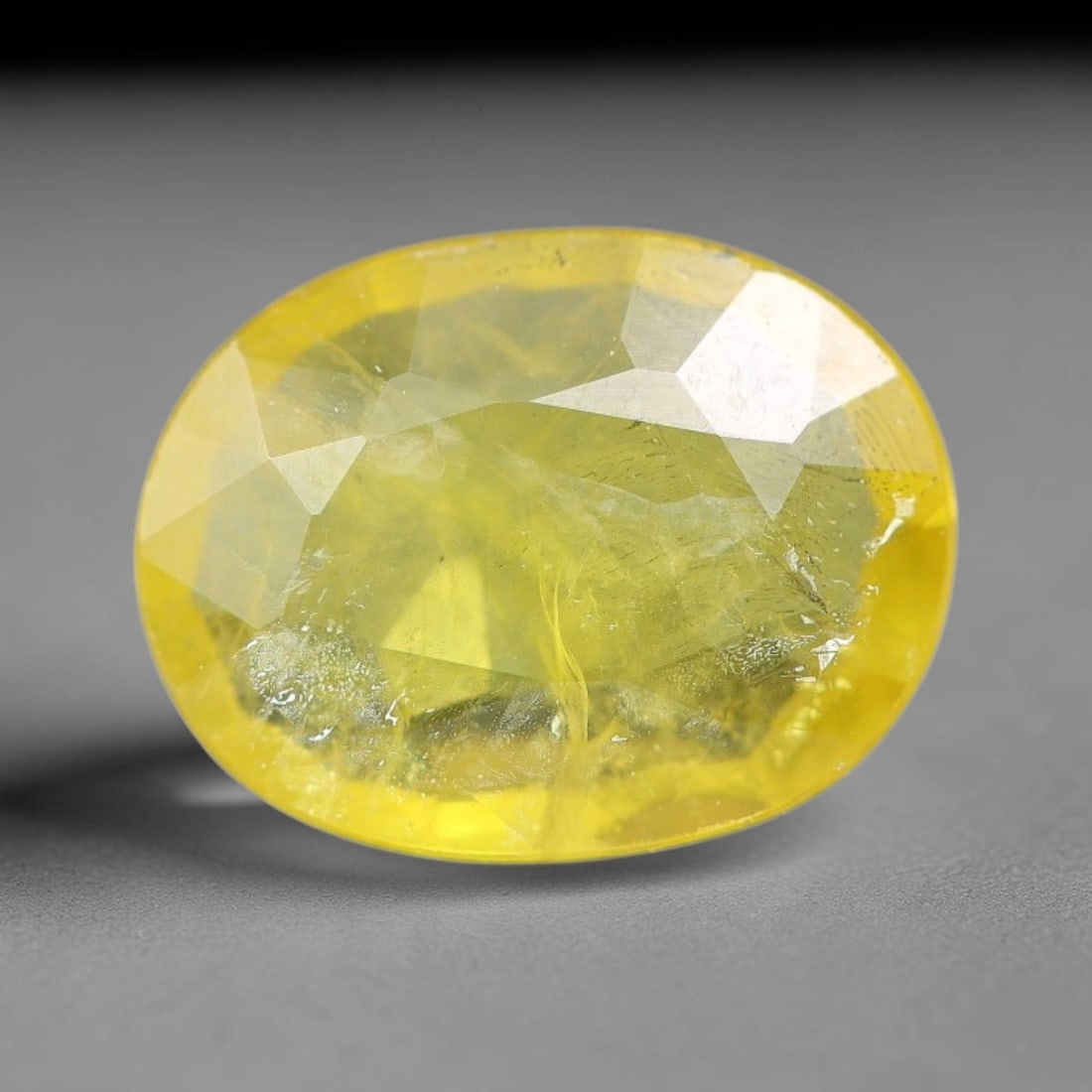 1.46 Carats Natural Yellow Sapphire Oval Faceted Loose Gemstone, 57YW: This natural yellow sapphire features a classic oval brilliant faceted cut, holding consistent warm golden-yellow color throughout the corundum crystal. Fine microscopic mineral specks and faint natur