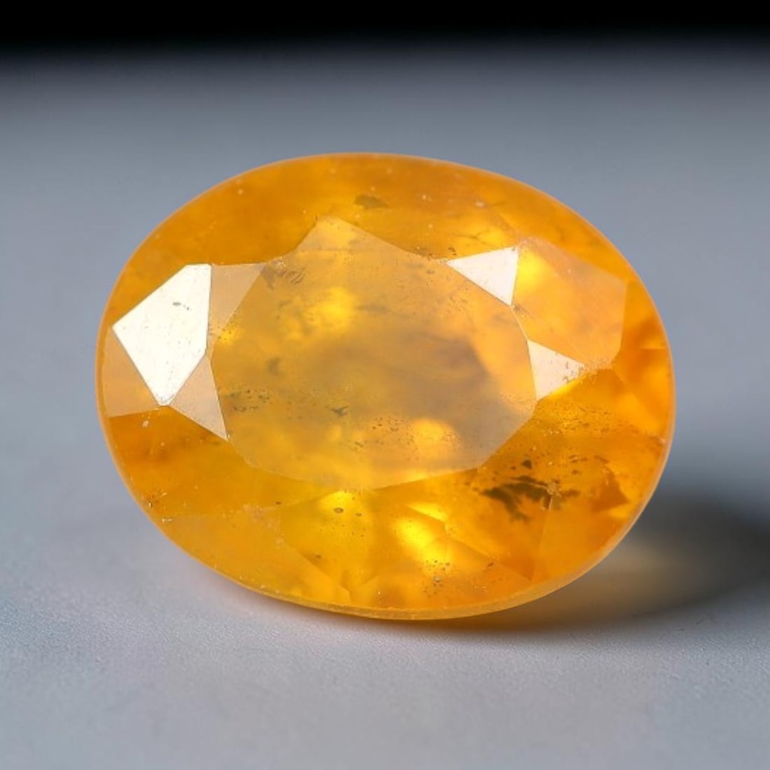 1.23 Carats Natural Yellow Sapphire Oval Faceted Loose Gemstone, 67TT: This natural yellow sapphire features a classic oval brilliant faceted cut, holding consistent warm golden-yellow color throughout the corundum crystal. Fine microscopic mineral specks and faint natur