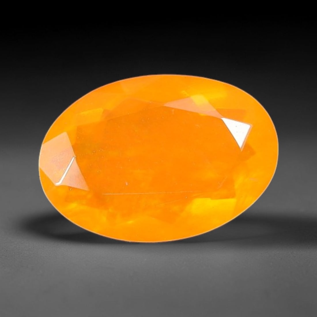 1.00 Carats Natural Ethiopian Welo Orange Fire Opal Oval Faceted Loose Gemstone, 76TS: This opal material is mined from the Welo deposits of Ethiopia and processed with professional faceted lapidary work with uniform polished facets across the gem surface. Natural subtle internal textur