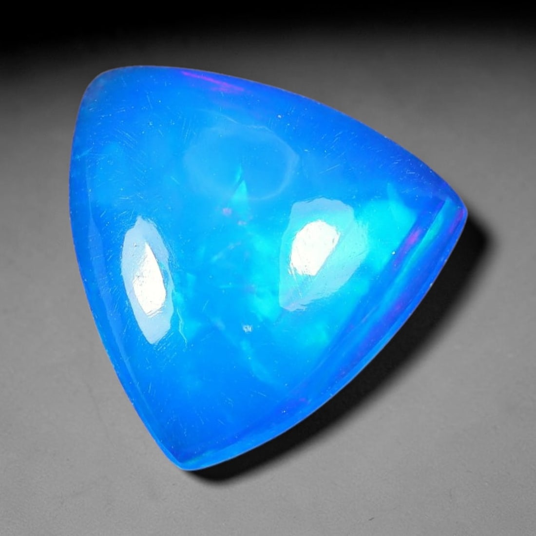 2.39ct Natural Ethiopian Welo Blue Fire Opal Cabochon Loose Gemstone, 79TS: This opal is sourced from Ethiopian Welo natural opal deposits and shaped into a smooth polished cabochon form with refined lapidary finishing work. Bright warm blue base accompanied by vivid internal