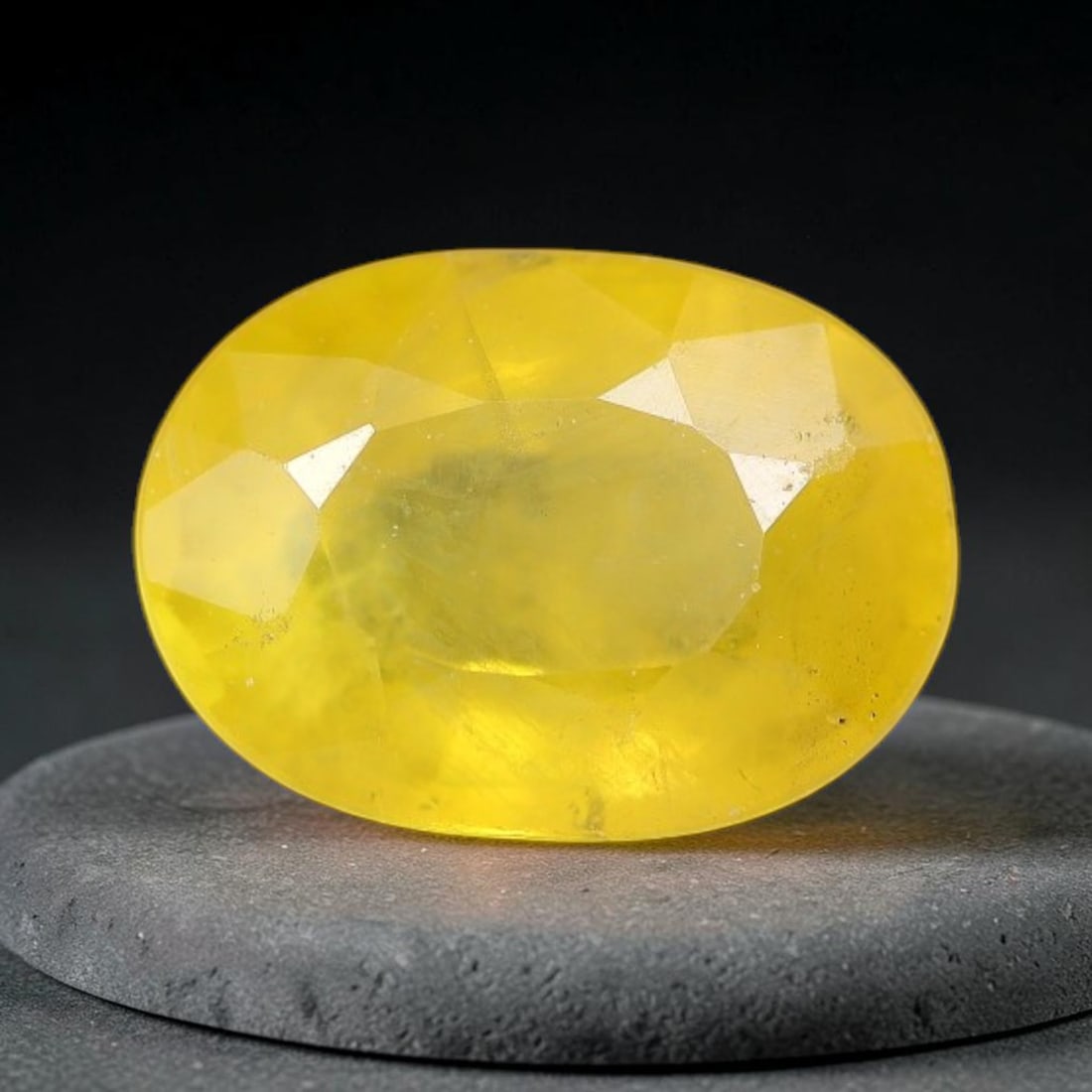 1.03 Carats Natural Yellow Sapphire Oval Faceted Loose Gemstone, 57TT: This natural yellow sapphire features a classic oval brilliant faceted cut, holding consistent warm golden-yellow color throughout the corundum crystal. Fine microscopic mineral specks and faint natur