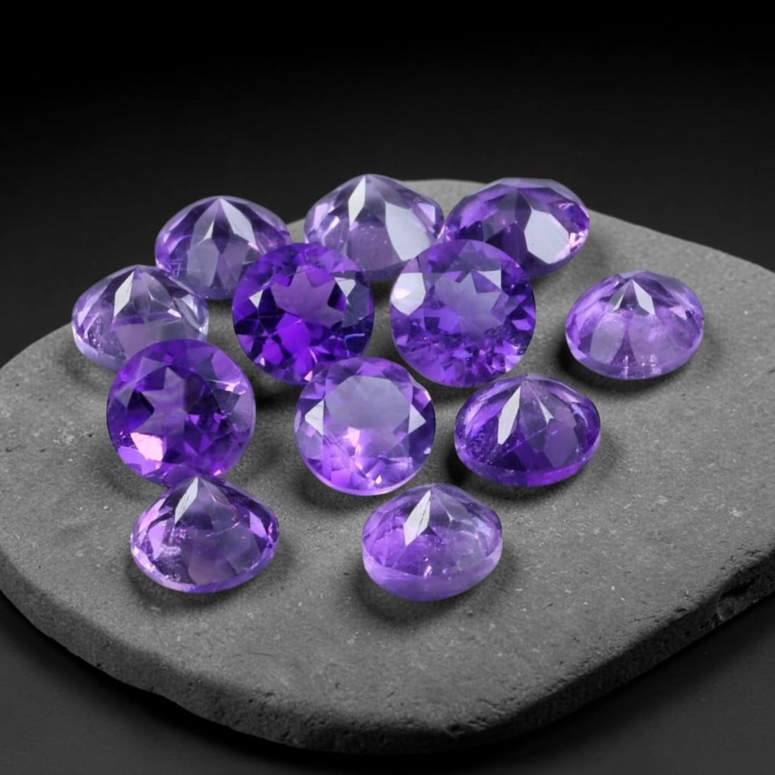 3.14ct Natural Purple Amethyst Round Cut Loose Gemstone Parcel, 20TZ: This parcel contains round faceted natural amethyst gemstones with aggregate total weight of 3.14 carats, each stone measuring 4.2x3.0mm. The gems display rich purple colouration with subtle natural i