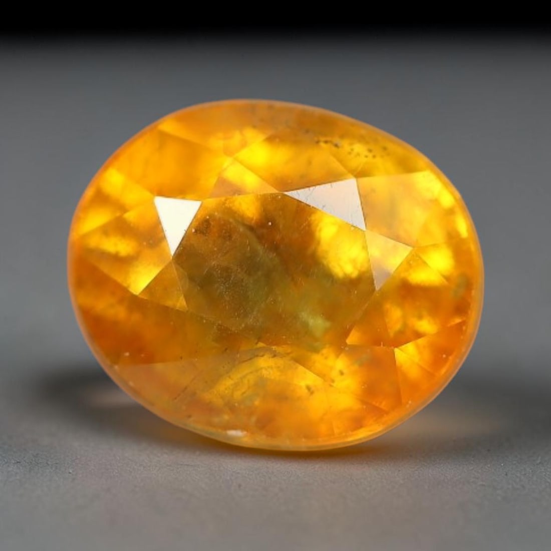 1.13 Carats Natural Yellow Sapphire Oval Faceted Loose Gemstone, 51TT: This natural yellow sapphire features a classic oval brilliant faceted cut, holding consistent warm golden-yellow color throughout the corundum crystal. Fine microscopic mineral specks and faint natur