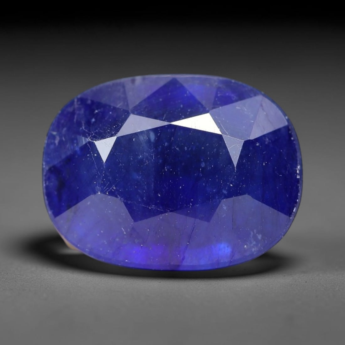 8.32 Carats Royal Blue Sapphire Oval Cut Loose Gemstone, 94TM: This neat oval cut sapphire showcases deep, saturated royal blue color, enhanced by clean reflective step facets. Natural internal fine fissures and scattered tiny mineral specks can be observed withi