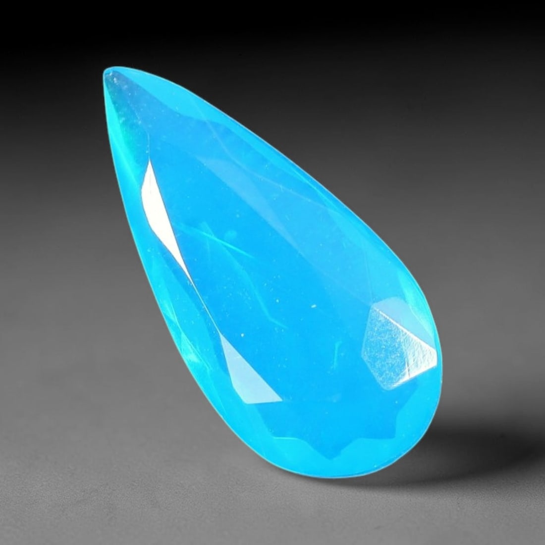 1.41 Carats Natural Ethiopian Welo Blue Fire Opal Pear Faceted Loose Gemstone, 82TS: This opal material is mined from the Welo deposits of Ethiopia and processed with professional faceted lapidary work with uniform polished facets across the gem surface. Natural subtle internal textur