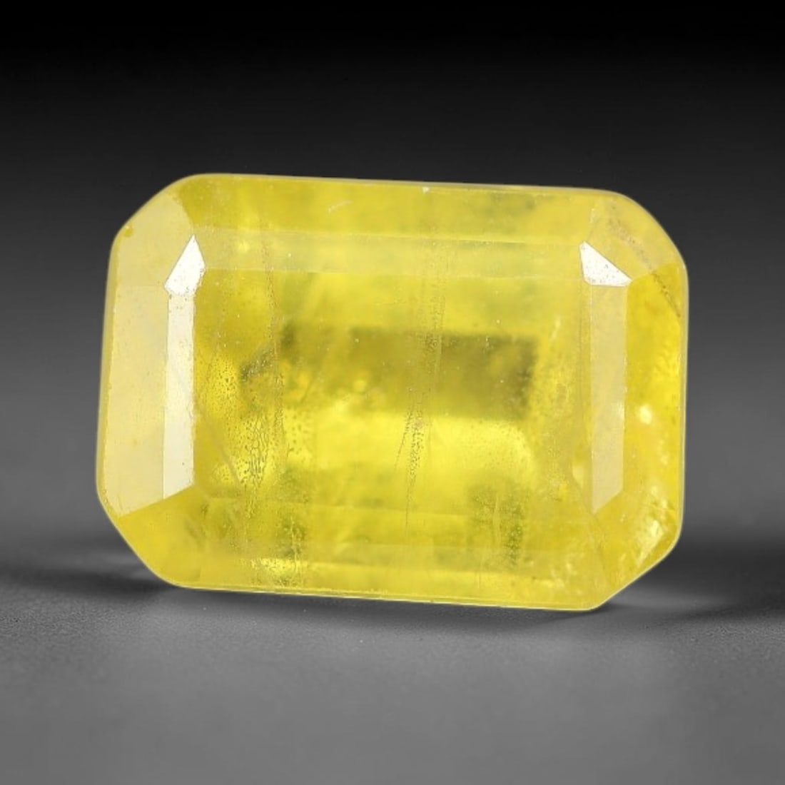1.54 Carats Natural Yellow Sapphire Octagon Faceted Loose Gemstone, 69TT: This natural yellow sapphire features a classic octagon brilliant faceted cut, holding consistent warm golden-yellow color throughout the corundum crystal. Fine microscopic mineral specks and faint na