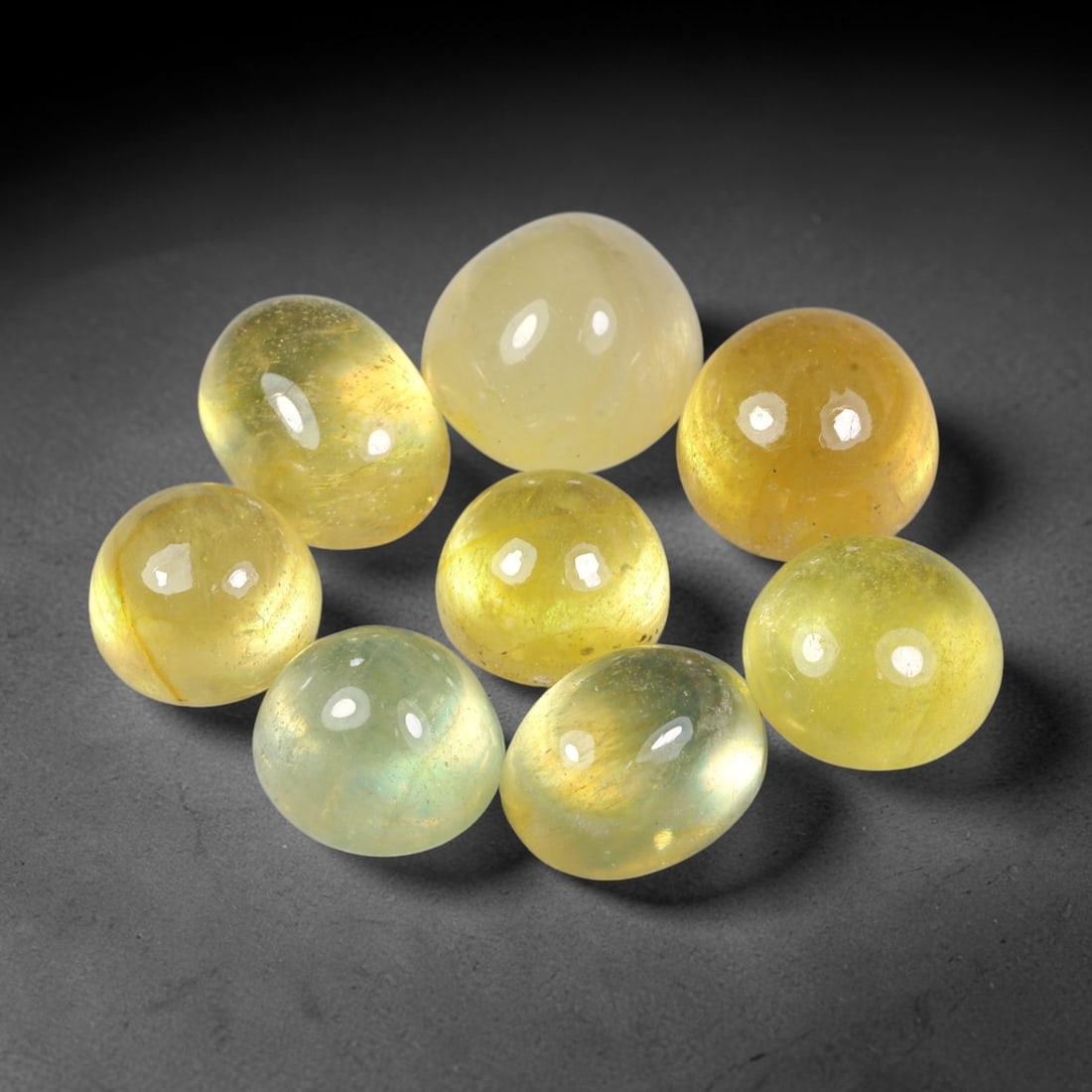 28.51ct Natural Yellow Sapphire Oval Cabochon Loose Gemstone Parcel, 68YW: This parcel oval cabochon natural yellow sapphires with each stone measuring 9.3x6.8x5.2mm. The gemstones display soft pale yellow colouration with natural internal inclusions; stones are fissure fill