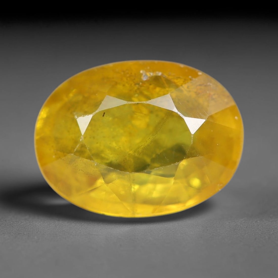 2.71 Carats Natural Yellow Sapphire Oval Faceted Loose Gemstone, 44YW: This natural yellow sapphire features a classic oval brilliant faceted cut, holding consistent warm golden-yellow color throughout the corundum crystal. Fine microscopic mineral specks and faint natur