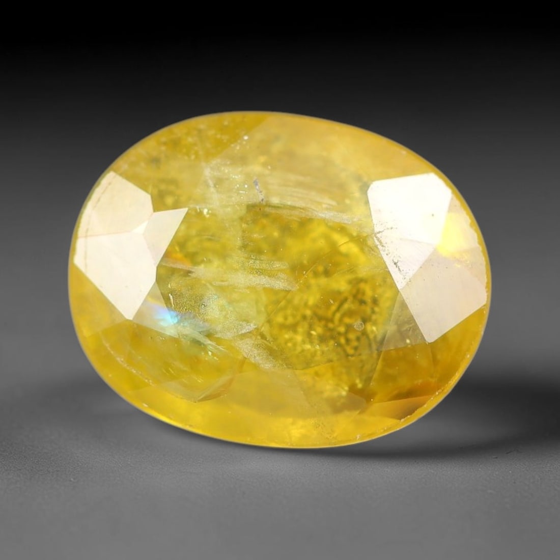 2.04 Carats Natural Yellow Sapphire Oval Faceted Loose Gemstone, 55YW: This natural yellow sapphire features a classic oval brilliant faceted cut, holding consistent warm golden-yellow color throughout the corundum crystal. Fine microscopic mineral specks and faint natur