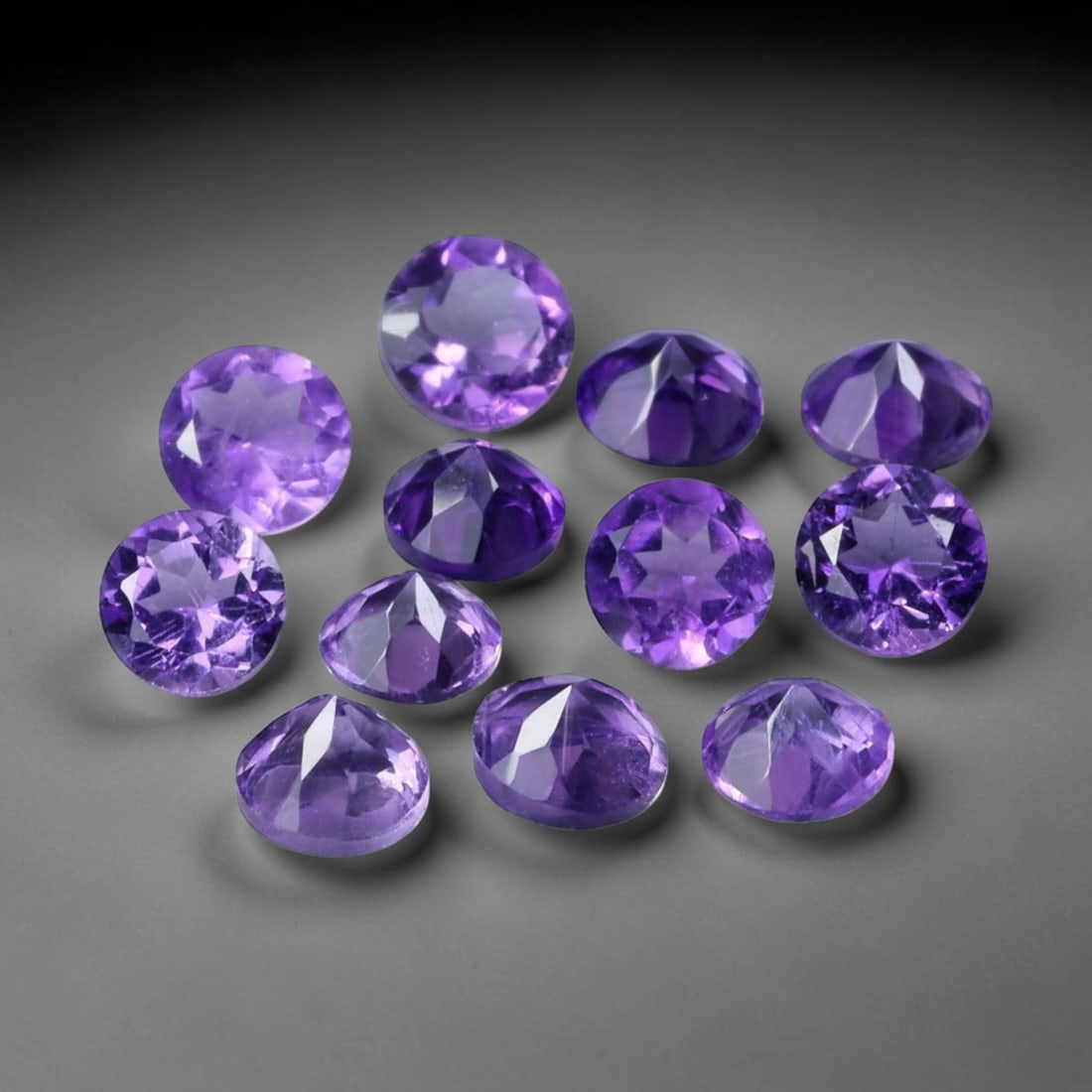 3.05ct Natural Purple Amethyst Round Cut Loose Gemstone Parcel, 22TZ: This parcel contains round faceted natural amethyst gemstones with aggregate total weight of 3.05 carats, each stone measuring 4.2x3.0mm. The gems display rich purple colouration with subtle natural i