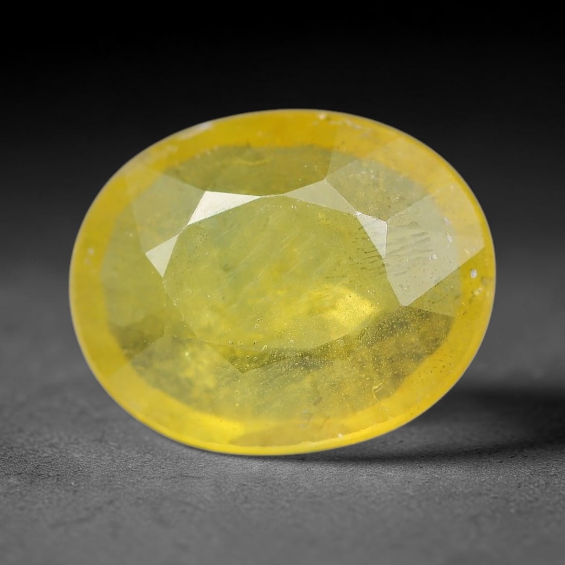2.13 Carats Natural Yellow Sapphire Oval Faceted Loose Gemstone, 48YW: This natural yellow sapphire features a classic oval brilliant faceted cut, holding consistent warm golden-yellow color throughout the corundum crystal. Fine microscopic mineral specks and faint natur