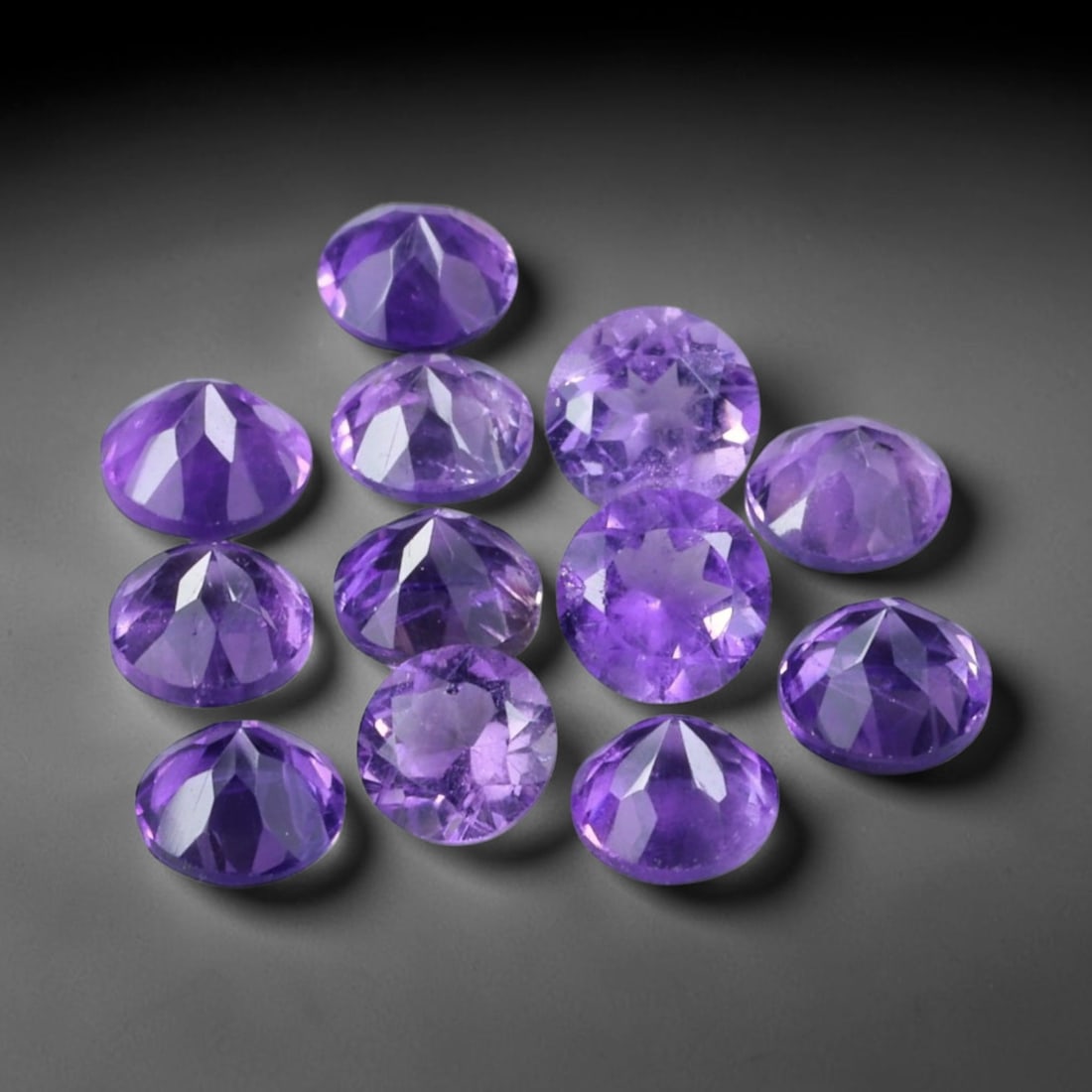 3.09ct Natural Purple Amethyst Round Cut Loose Gemstone Parcel, 19TZ: This parcel contains round faceted natural amethyst gemstones with aggregate total weight of 3.09 carats, each stone measuring 4.3x3.0mm. The gems display rich purple colouration with subtle natural i