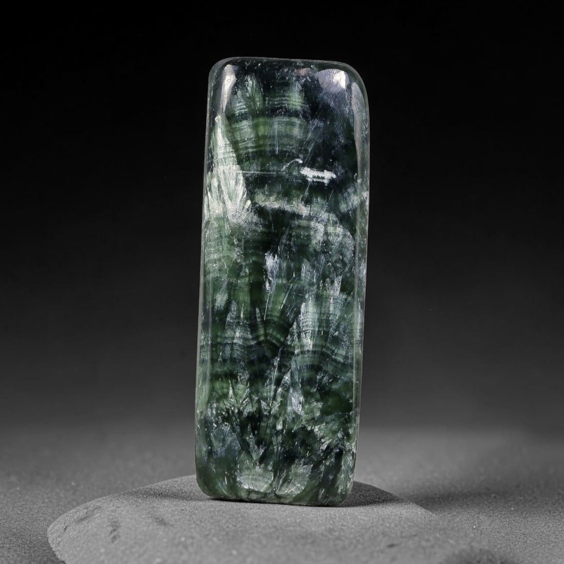 13.97 Carats Natural Deep Green Siberian Seraphinite Polished Cabochon, 77TZ: This is a fully natural polished seraphinite specimen sourced from Siberian deposits, displaying distinct feathery fibrous inclusions that create beautiful flowing chatoyant patterns across its smooth