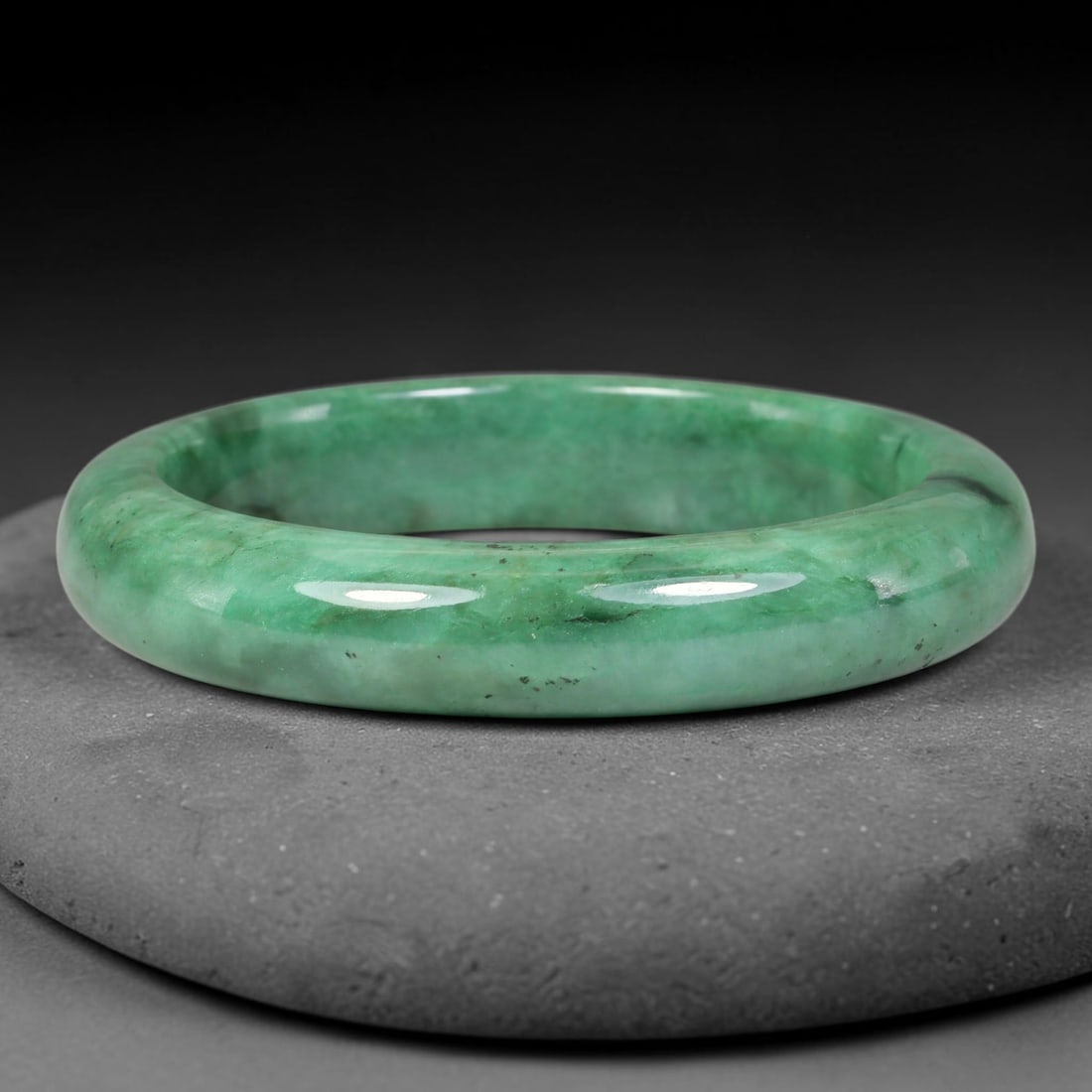 Natural Burmese Type A Dark Speckled Floating Green Jadeite Jade Bangle Bracelet, 55TD: This glossy polished jadeite bangle features rich saturated green tones with natural dark speckled mineral inclusions across the band. Inner dimension 58.5x13.2mm, smooth rounded wide profile with a l