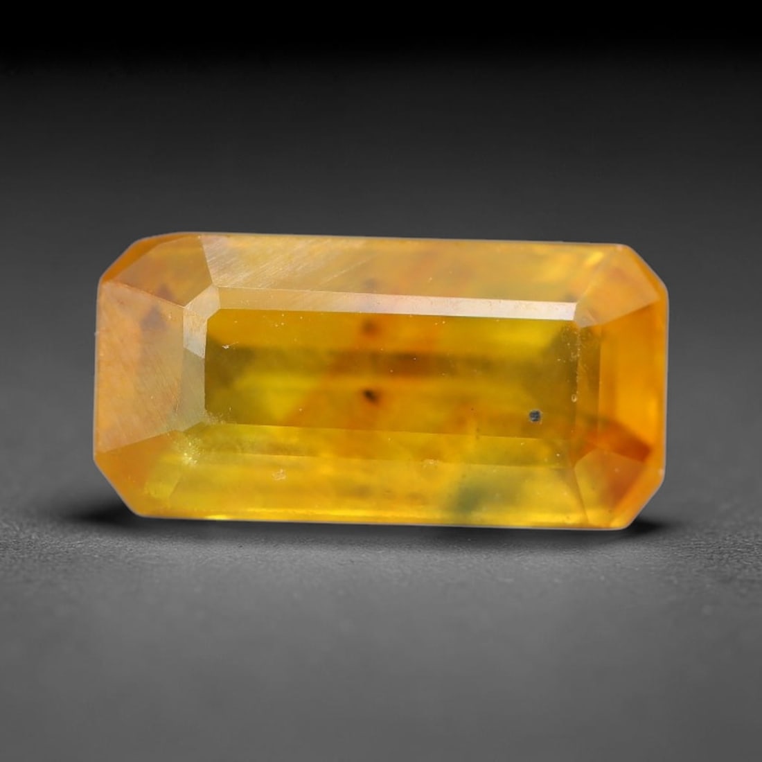 1.69 Carats Natural Yellow Sapphire Octagon Faceted Loose Gemstone, 61TT: This natural yellow sapphire features a classic octagon brilliant faceted cut, holding consistent warm golden-yellow color throughout the corundum crystal. Fine microscopic mineral specks and faint na