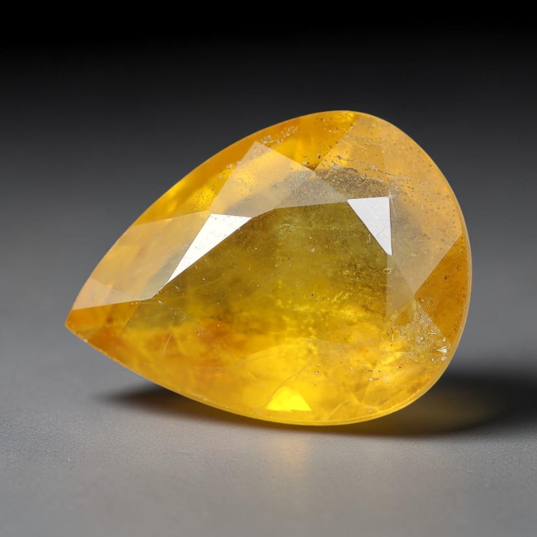 2.01 Carats Natural Yellow Sapphire Pear Faceted Loose Gemstone, 88TT: This natural yellow sapphire features a classic Pear brilliant faceted cut, holding consistent warm golden-yellow color throughout the corundum crystal. Fine microscopic mineral specks and faint natur