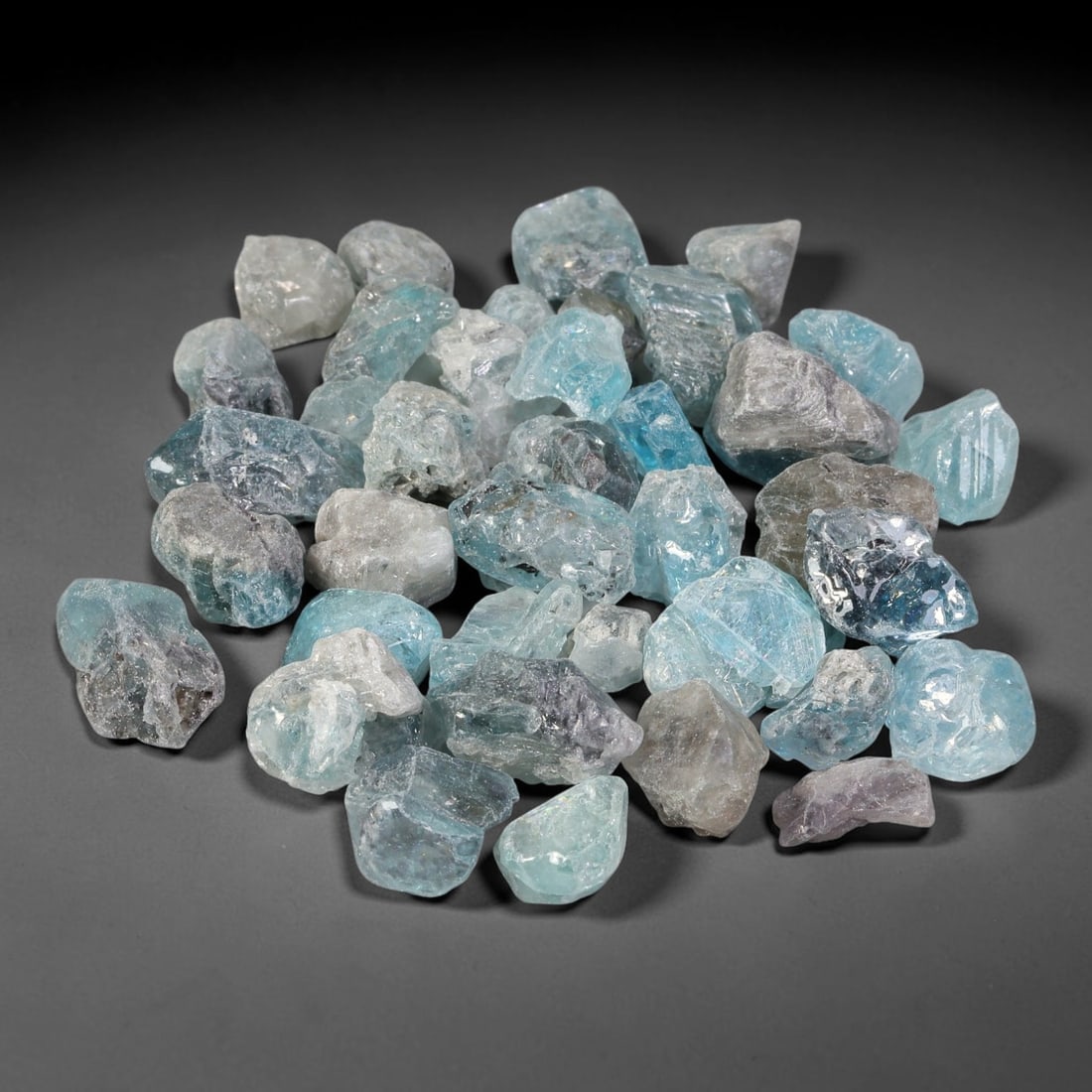 246.97ct Natural Cambodian Blue Zircon Rough Parcel Loose Gemstone, 86YT: This parcel consists of natural unpolished blue zircon rough crystals with translucent sky-blue to teal hues, featuring natural crystalline textures and facets. Minor matrix and inclusions are visible