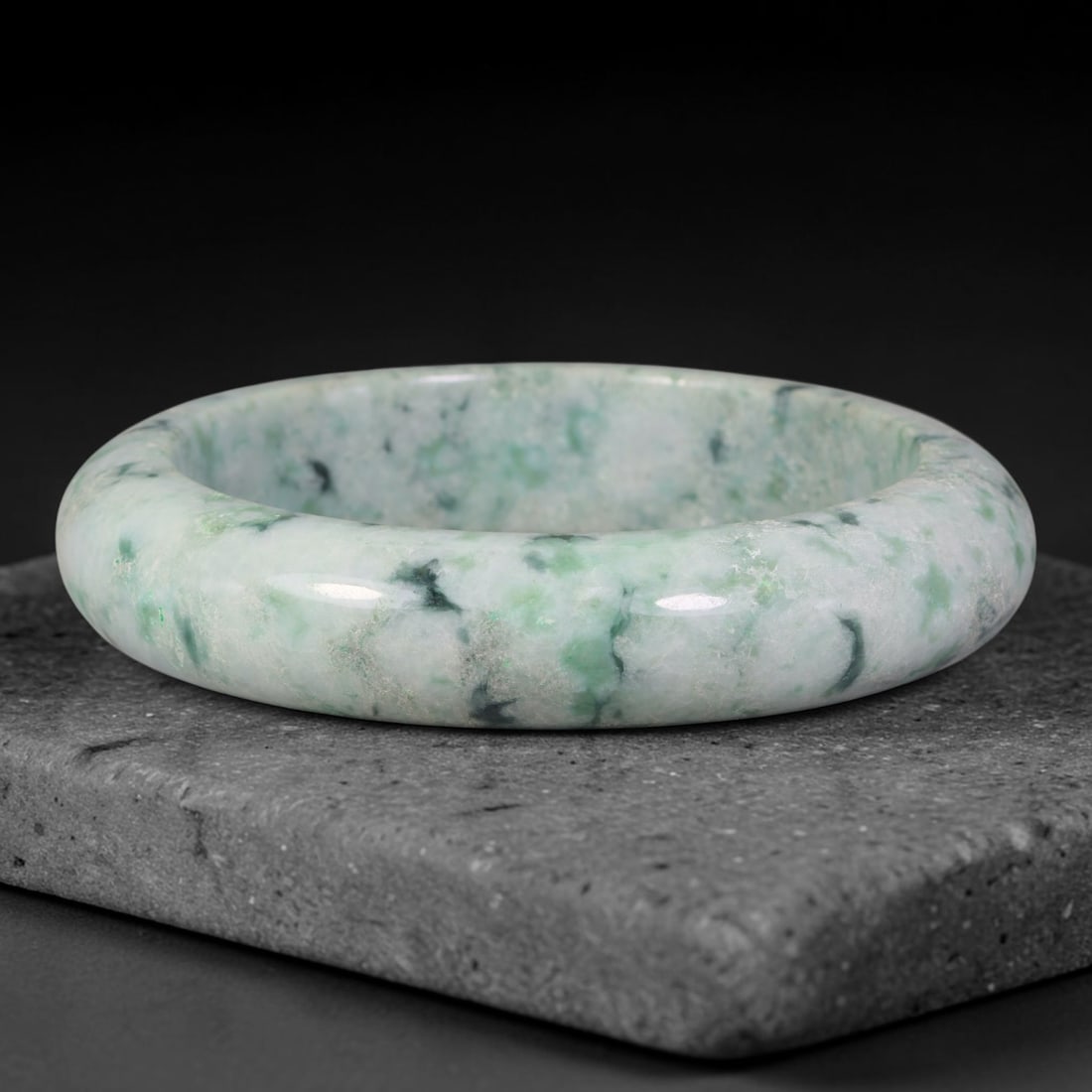 Natural Burmese Type A Dark Speckled Floating Green Jadeite Jade Bangle Bracelet, 87TD: Polished jadeite bangle with creamy pale base scattered with dark speckled floating green inclusions. Inner dimension 61.2x15.3mm, solid rounded band with smooth glossy finish. Natural mottled green m