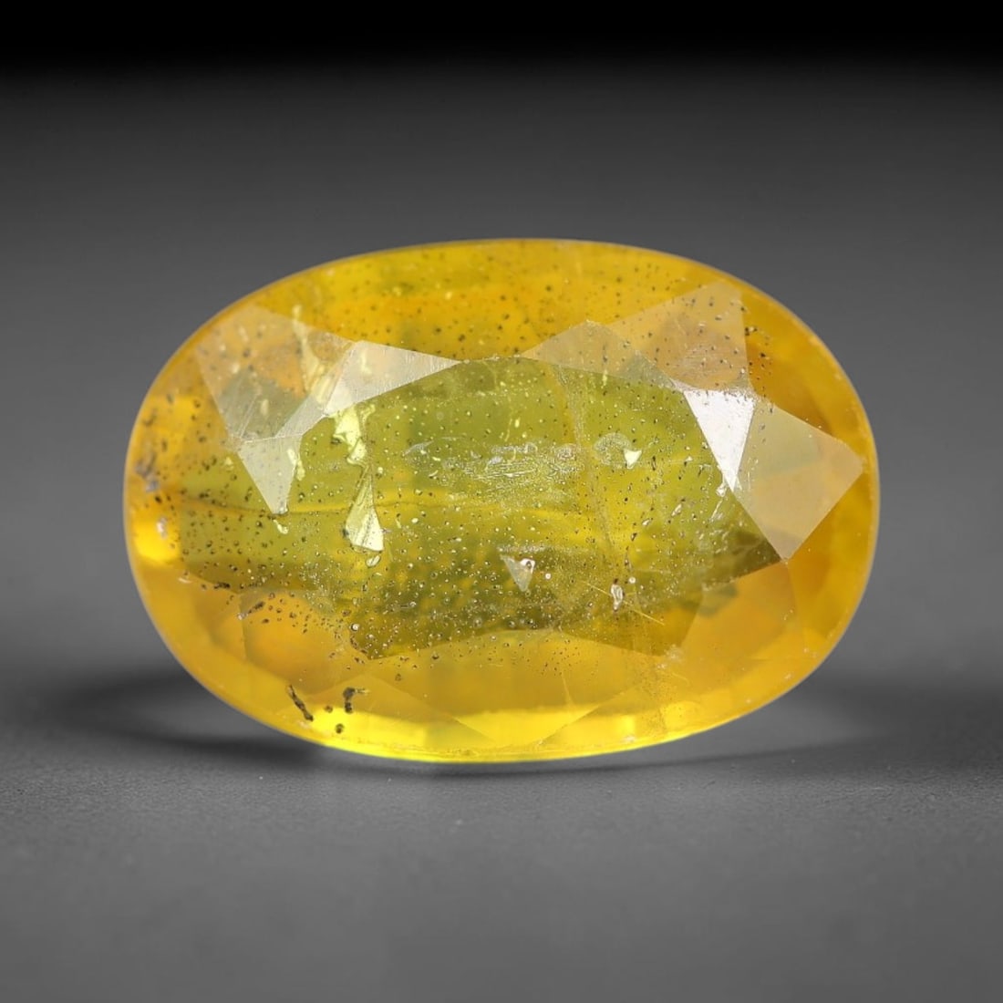 2.55 Carats Natural Yellow Sapphire Oval Faceted Loose Gemstone, 43YW: This natural yellow sapphire features a classic oval brilliant faceted cut, holding consistent warm golden-yellow color throughout the corundum crystal. Fine microscopic mineral specks and faint natur
