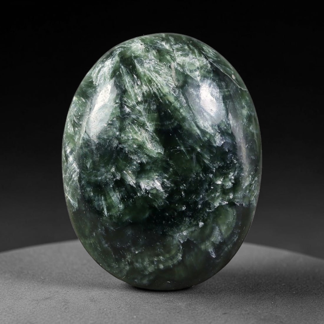 15.87 Carats Natural Deep Green Siberian Seraphinite Polished Cabochon, 36TZ: This is a fully natural polished seraphinite specimen sourced from Siberian deposits, displaying distinct feathery fibrous inclusions that create beautiful flowing chatoyant patterns across its smooth