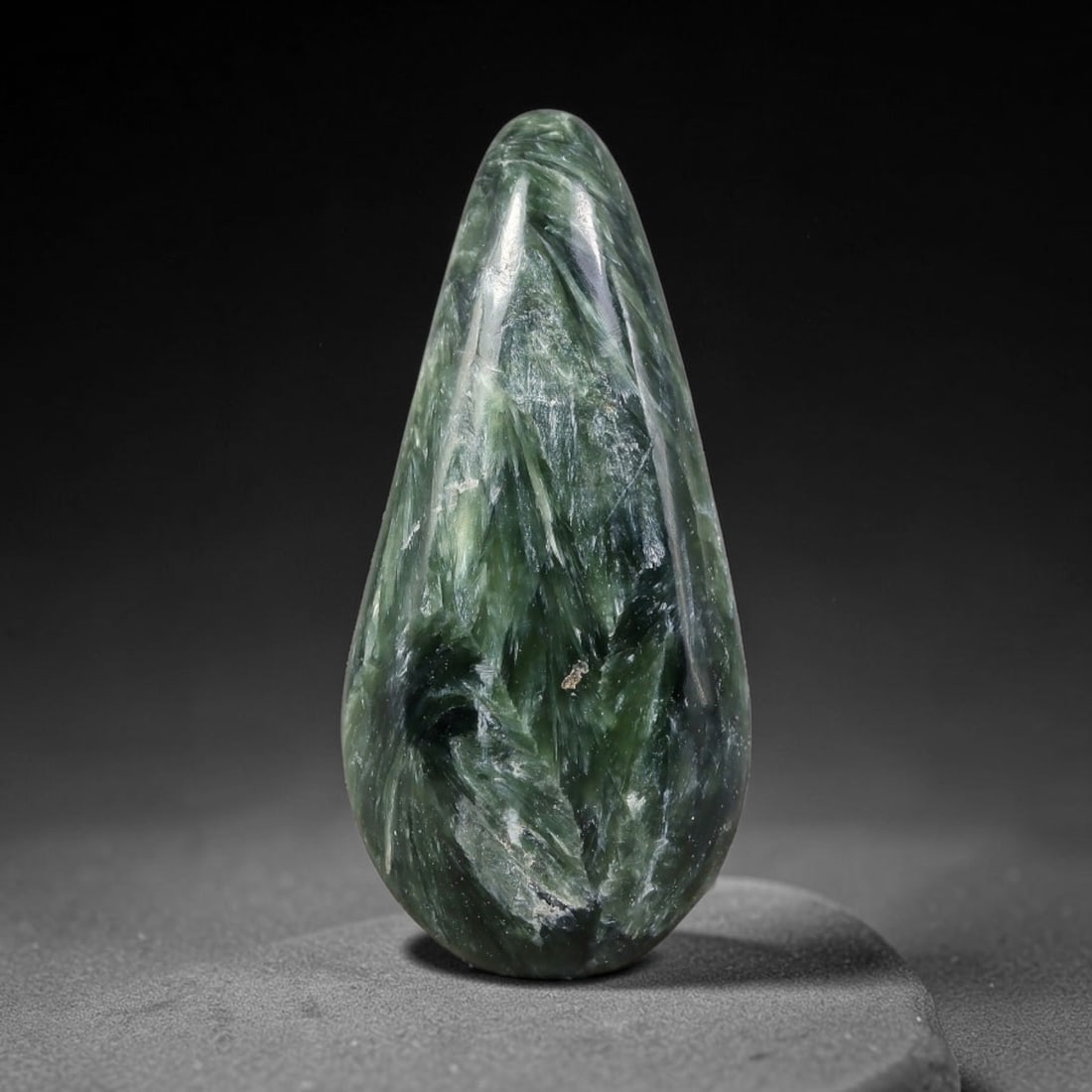 12.92 Carats Natural Deep Green Siberian Seraphinite Polished Cabochon, 34TZ: This is a fully natural polished seraphinite specimen sourced from Siberian deposits, displaying distinct feathery fibrous inclusions that create beautiful flowing chatoyant patterns across its smooth