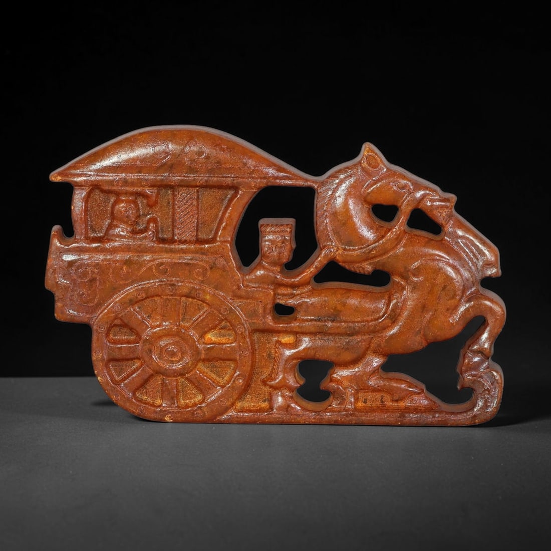 A Chinese Open-Work Carved Reddish-Brown Jade Stone Horse-Drawn Carriage Plaque, 97YF: Open-work jade plaque finely carved with a detailed scene of a horse-drawn ancient carriage. Relief carving depicts the horse, chariot wheels, driver and passenger figures, with multiple pierced cut-o
