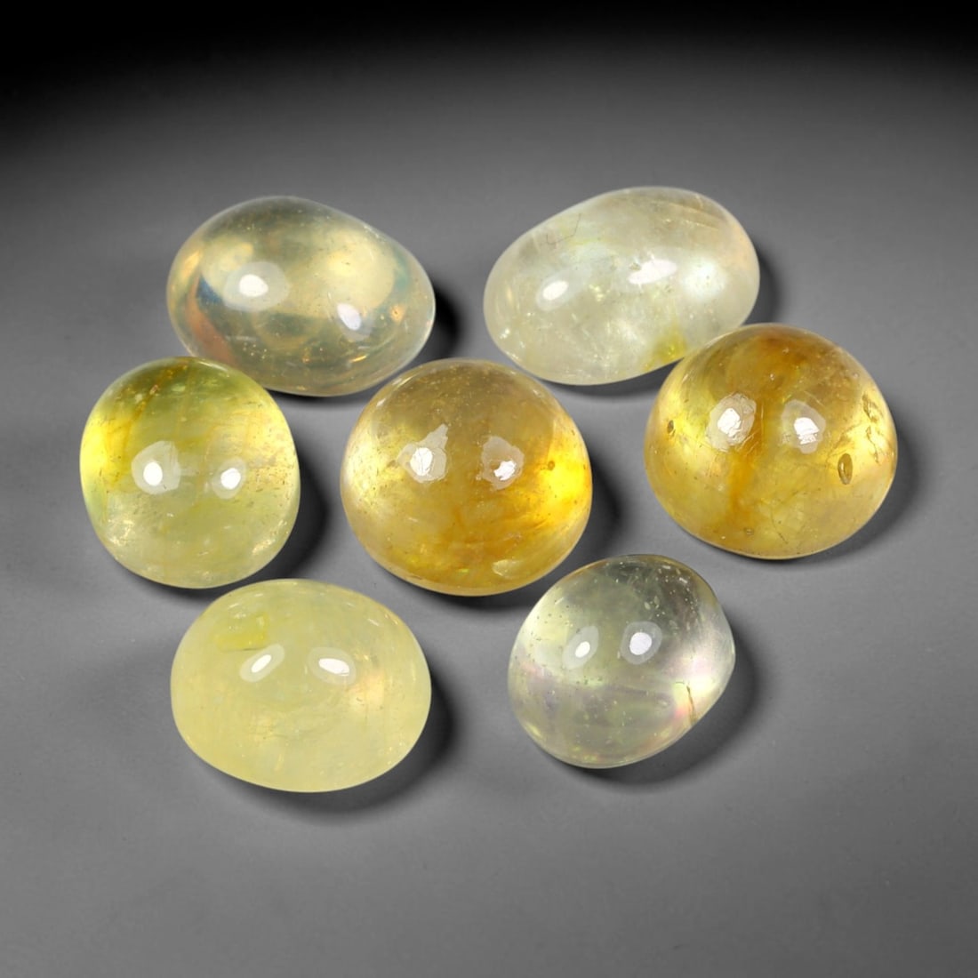 14.68ct Natural Yellow Sapphire Oval Cabochon Loose Gemstone Parcel, 65YW: This parcel oval cabochon natural yellow sapphires with each stone measuring 7.7x6.3x3.6mm. The gemstones display soft pale yellow colouration with natural internal inclusions; stones are fissure fill
