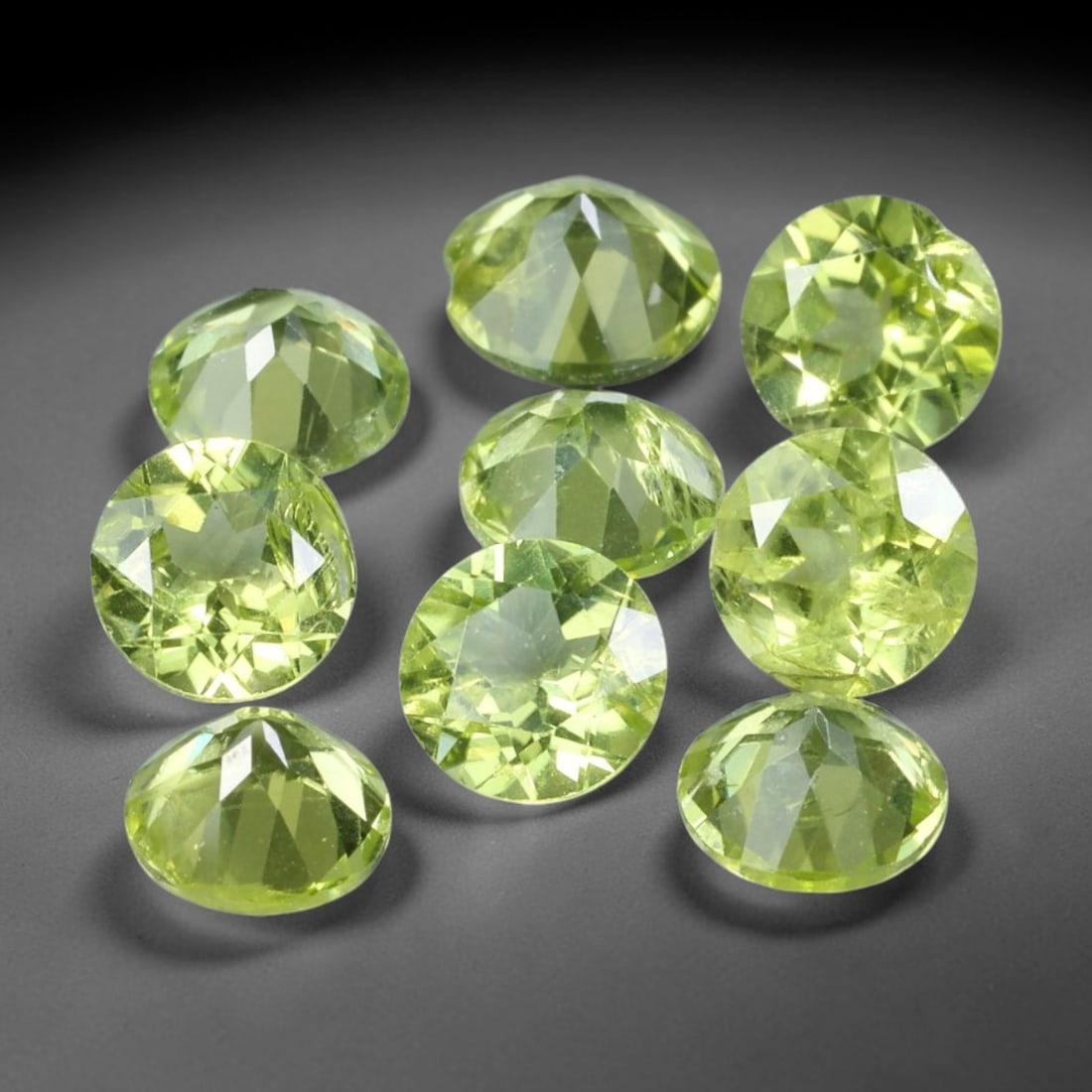 4.55ct Natural Olive Green Peridot Round Cut Loose Gemstone 9pcs Parcel, 8TT: This parcel contains nine round faceted natural peridots with total aggregate weight of 4.55 carats, each stone measuring 5.4x3.1mm. The gemstones show bright olive-green colouration with fine natural