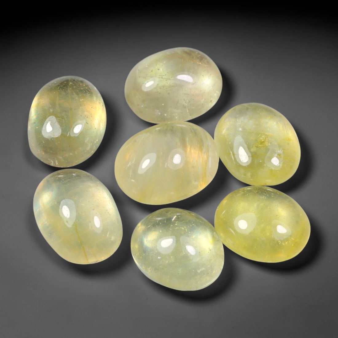 15.08ct Natural Yellow Sapphire Oval Cabochon Loose Gemstone Parcel, 66YW: This parcel oval cabochon natural yellow sapphires with each stone measuring 9.0x6.3x4.1mm. The gemstones display soft pale yellow colouration with natural internal inclusions; stones are fissure fill