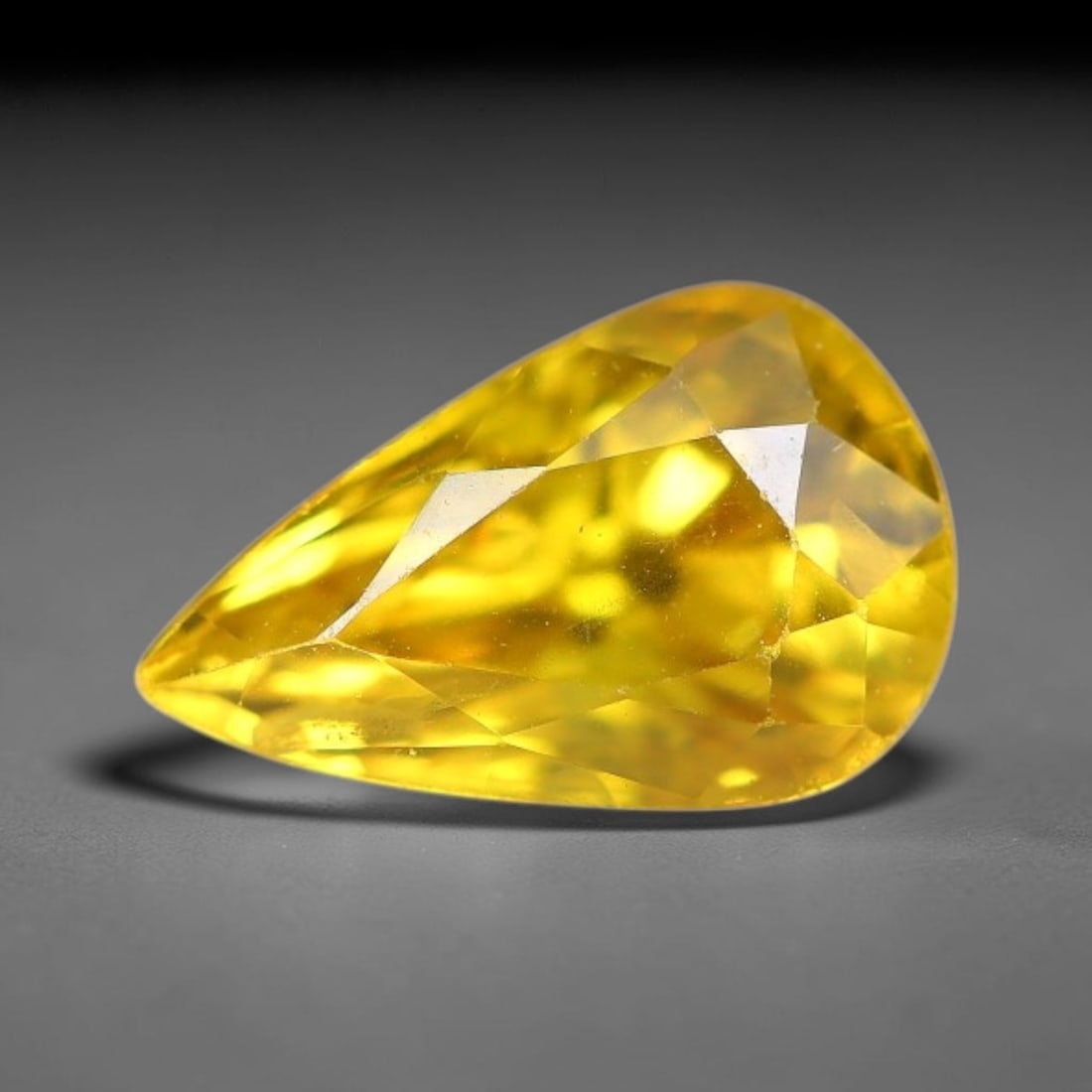 1.01 Carats Natural Yellow Sapphire Pear Faceted Loose Gemstone, 74TT: This natural yellow sapphire features a classic Pear brilliant faceted cut, holding consistent warm golden-yellow color throughout the corundum crystal. Fine microscopic mineral specks and faint natur