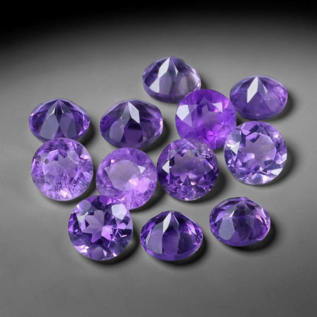 3.25ct Natural Purple Amethyst Round Cut Loose Gemstone Parcel, 21TZ: This parcel contains round faceted natural amethyst gemstones with aggregate total weight of 3.25 carats, each stone measuring 4.1x2.8mm. The gems display rich purple colouration with subtle natural i
