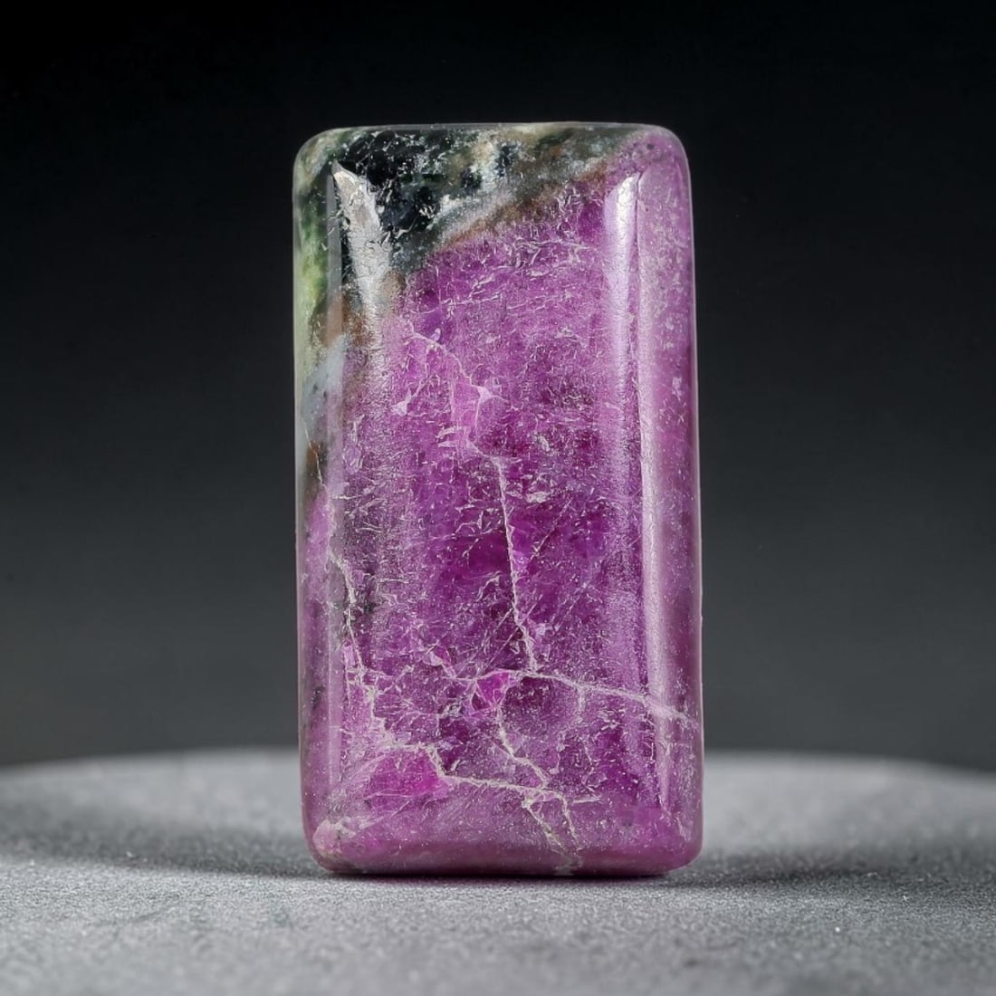 15.60ct Natural Ruby Zoisite Cabochon Loose Gemstone, 6TY: Natural ruby zoisite cabochon cut, dimensions 19.8x10.9x5.0mm. Rich magenta and deep purple swirling colour pattern with natural mineral veining across the polished surface. Smooth polished cabochon f