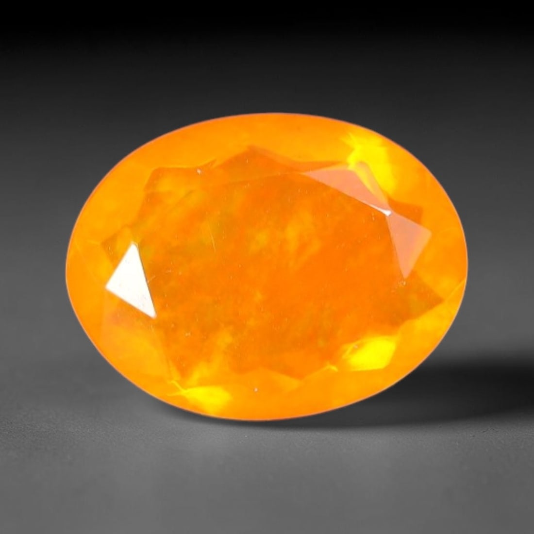 1.47 Carats Natural Ethiopian Welo Orange Fire Opal Oval Faceted Loose Gemstone, 75TS: This opal material is mined from the Welo deposits of Ethiopia and processed with professional faceted lapidary work with uniform polished facets across the gem surface. Natural subtle internal textur