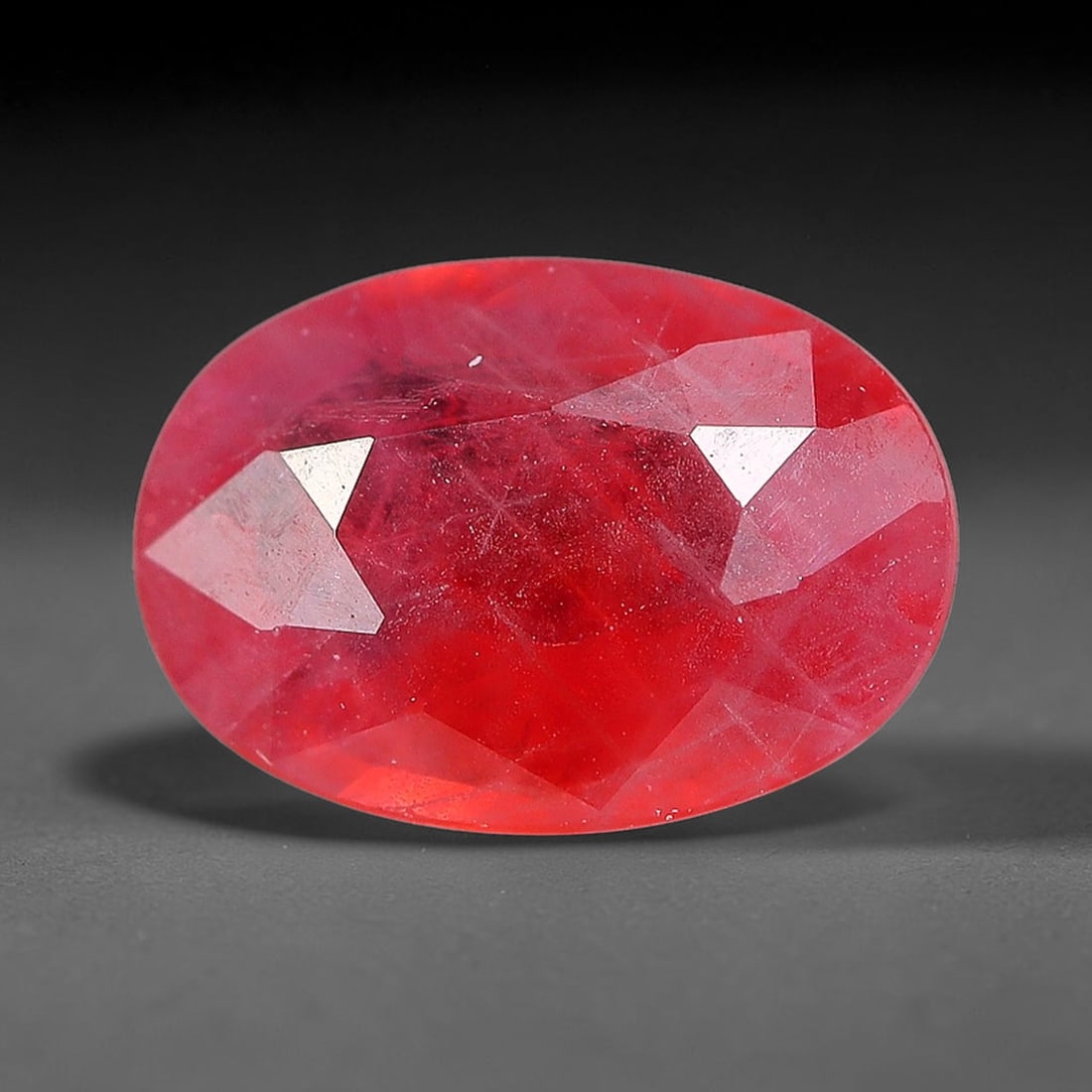 0.79 Carats Natural Orange Sapphire Oval Faceted Loose Gemstone, 75YW: This natural orange sapphire is fashioned in a classic oval brilliant faceted cut, presenting soft warm orange hues consistent with natural corundum specimens. Fine scattered mineral specks and faint 