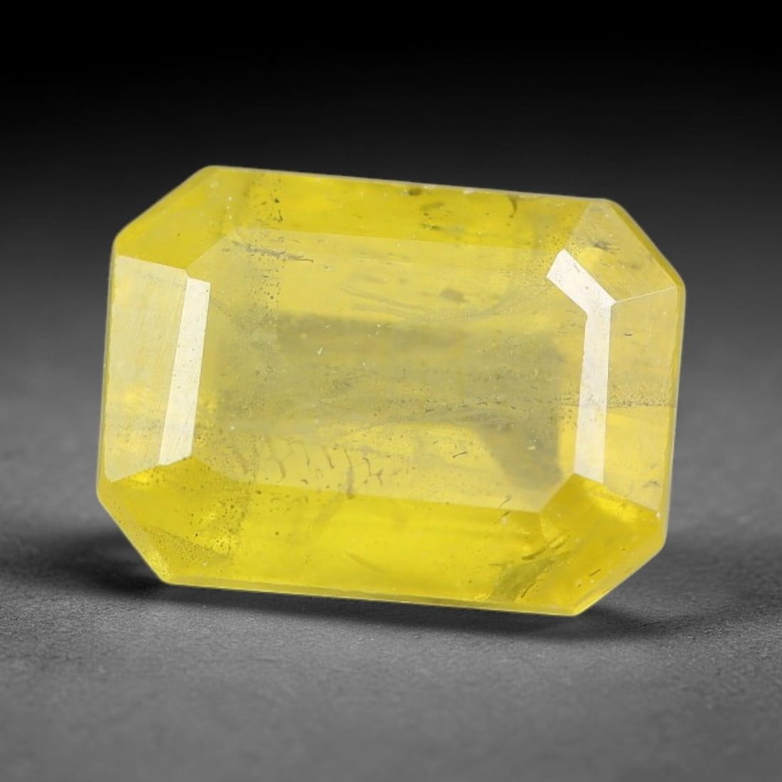 1.57 Carats Natural Yellow Sapphire Octagon Faceted Loose Gemstone, 87TT: This natural yellow sapphire features a classic octagon brilliant faceted cut, holding consistent warm golden-yellow color throughout the corundum crystal. Fine microscopic mineral specks and faint na