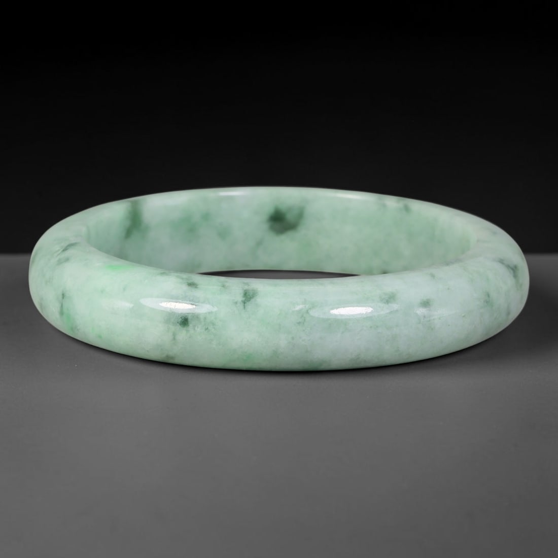 Natural Burmese Type A Dark Speckled Floating Green Jadeite Jade Bangle Bracelet, 88TD: Beautifully polished jadeite bangle with soft pale green base dotted with dark speckled floating green patches. Inner dimension 58.4x13.3mm, smooth rounded band with natural glossy finish. Organic sca