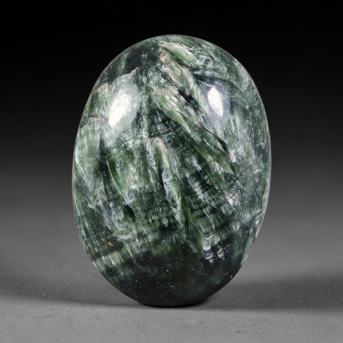 15.01 Carats Natural Deep Green Siberian Seraphinite Polished Cabochon, 33TZ: This is a fully natural polished seraphinite specimen sourced from Siberian deposits, displaying distinct feathery fibrous inclusions that create beautiful flowing chatoyant patterns across its smooth