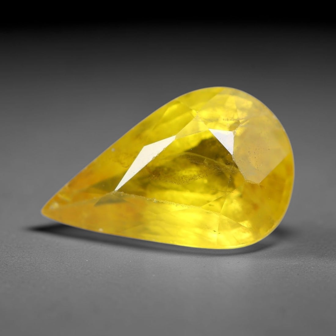 1.72 Carats Natural Yellow Sapphire Pear Faceted Loose Gemstone, 85TT: This natural yellow sapphire features a classic Pear brilliant faceted cut, holding consistent warm golden-yellow color throughout the corundum crystal. Fine microscopic mineral specks and faint natur