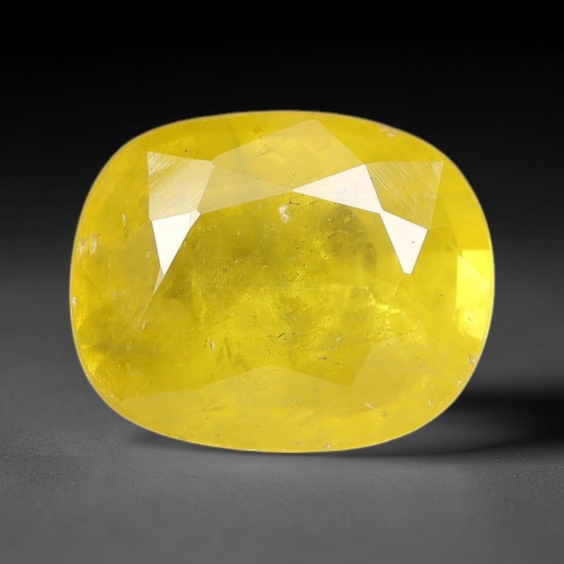 2.10 Carats Natural Yellow Sapphire Oval Faceted Loose Gemstone, 20TT: This natural yellow sapphire features a classic oval brilliant faceted cut, holding consistent warm golden-yellow color throughout the corundum crystal. Fine microscopic mineral specks and faint natur