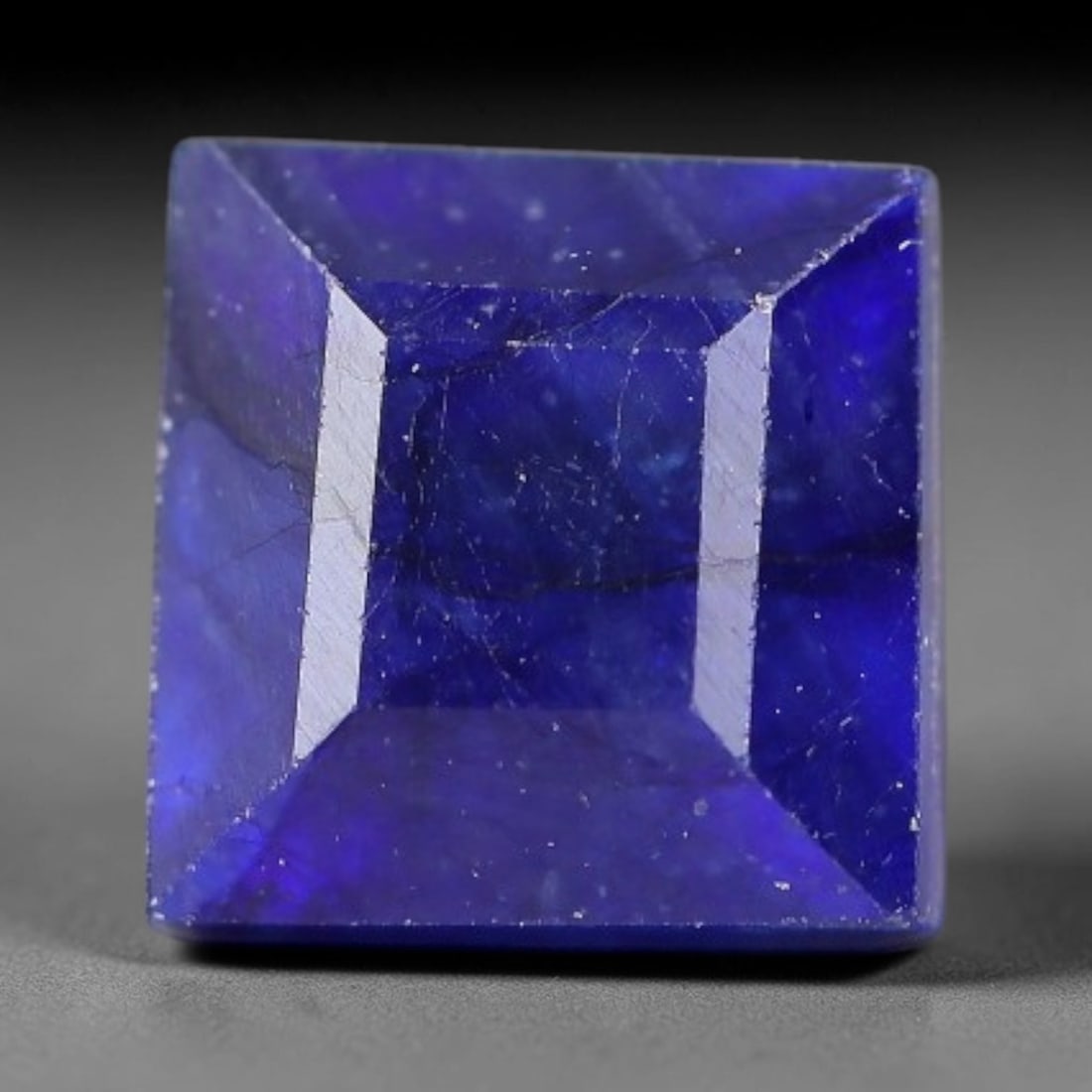 2.46 Carats Royal Blue Sapphire Square Emerald Cut Loose Gemstone, 97TS: This neat square emerald cut sapphire showcases deep, saturated royal blue color, enhanced by clean reflective step facets. Natural internal fine fissures and scattered tiny mineral specks can be obse