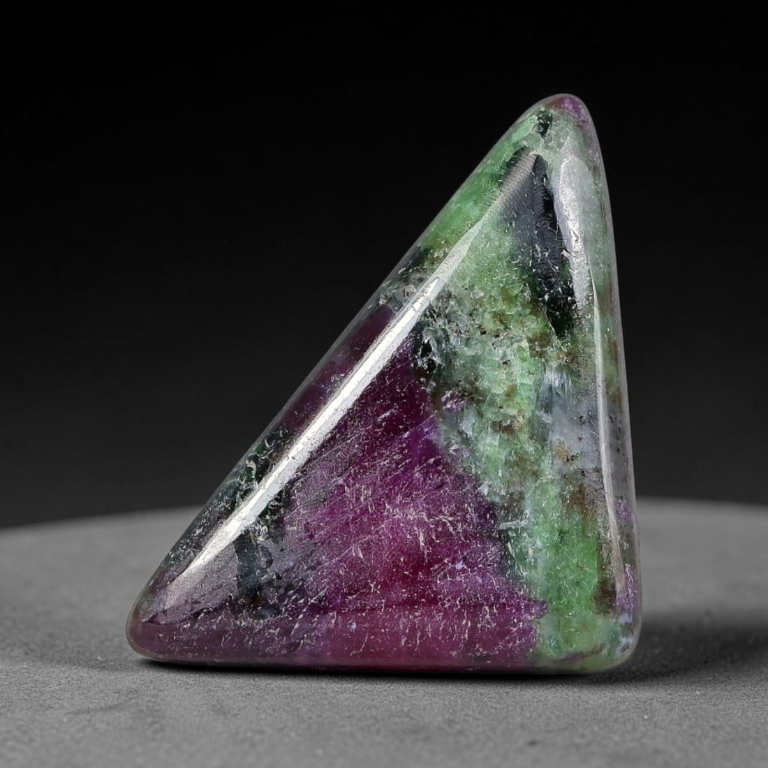 14.61ct Natural Ruby Zoisite Cabochon Loose Gemstone, 10TY: Natural ruby zoisite cabochon cut, dimensions 23.6x14.3x5.4mm. Rich magenta and deep purple swirling colour pattern with natural mineral veining across the polished surface. Smooth polished cabochon f