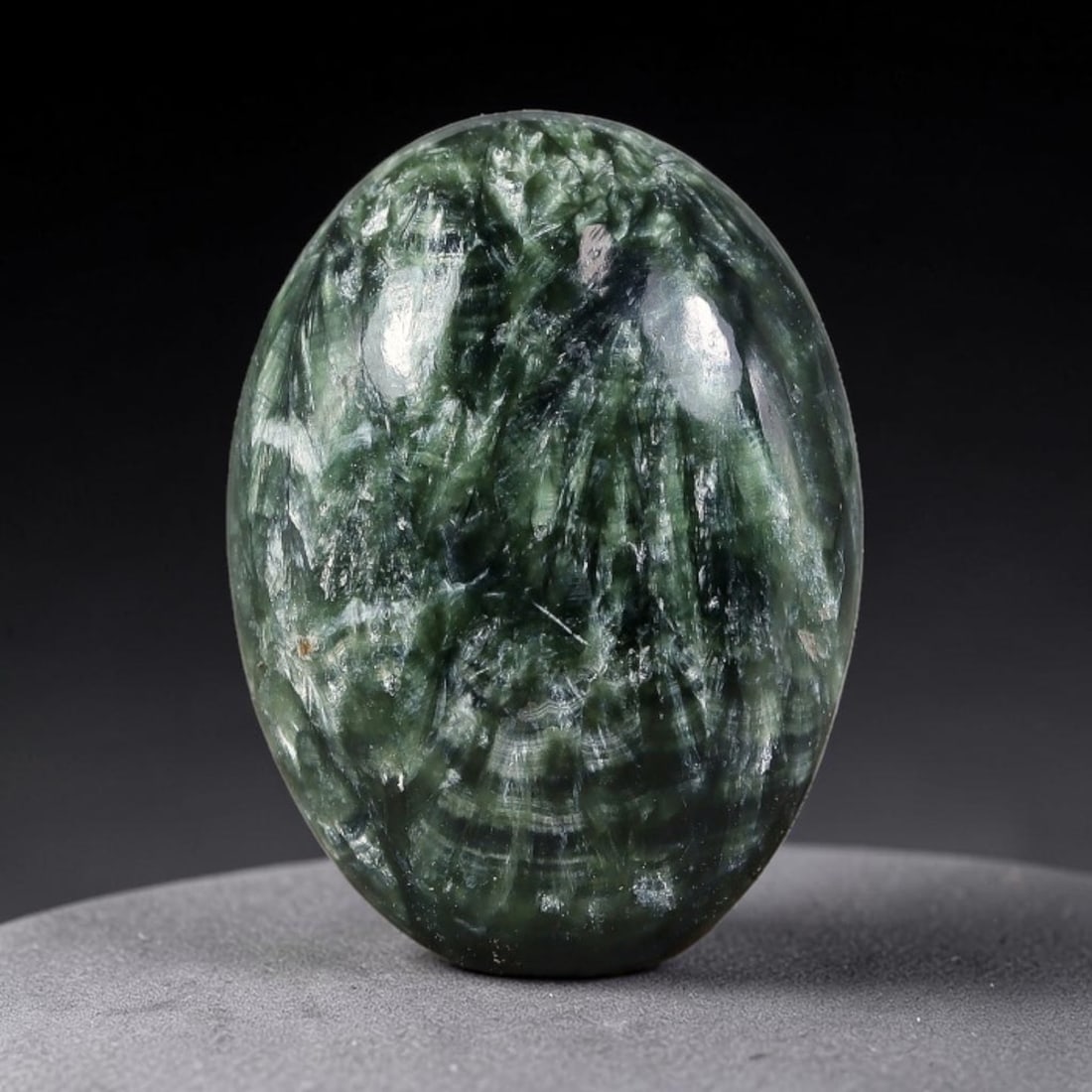 13.25 Carats Natural Deep Green Siberian Seraphinite Polished Cabochon, 58TZ: This is a fully natural polished seraphinite specimen sourced from Siberian deposits, displaying distinct feathery fibrous inclusions that create beautiful flowing chatoyant patterns across its smooth