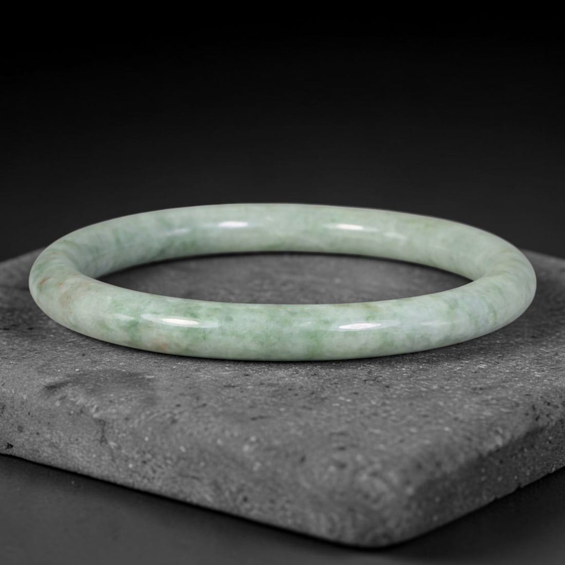 Natural Burmese Type A Pale Floating Green Jadeite Jade Slim Bangle Bracelet, 85TD: Smoothly polished slim jadeite bangle with soft pale celadon base and gentle floating green mottling, accented by tiny russet flecks. Inner dimension 59.6x8.0mm, thin rounded band with subtle natural 